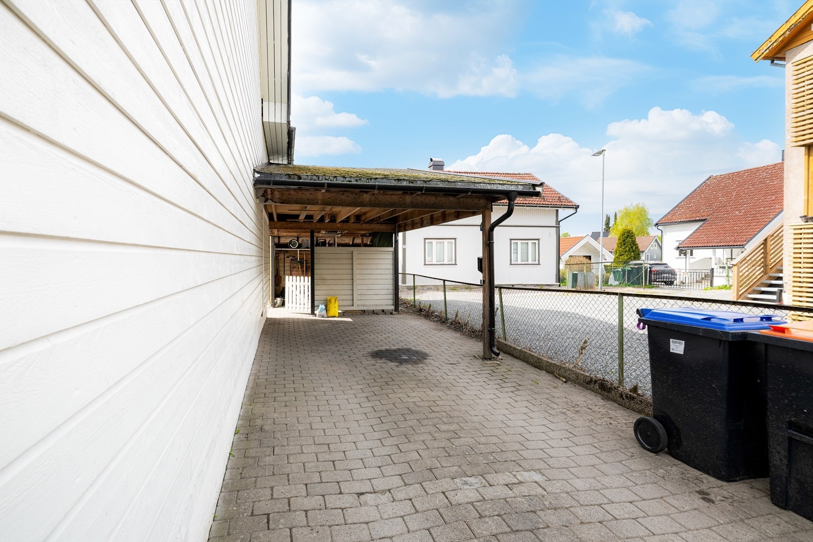 Det er parkering i carport, hvor det er gjennomgang til baksiden av boligen. Galleribilde