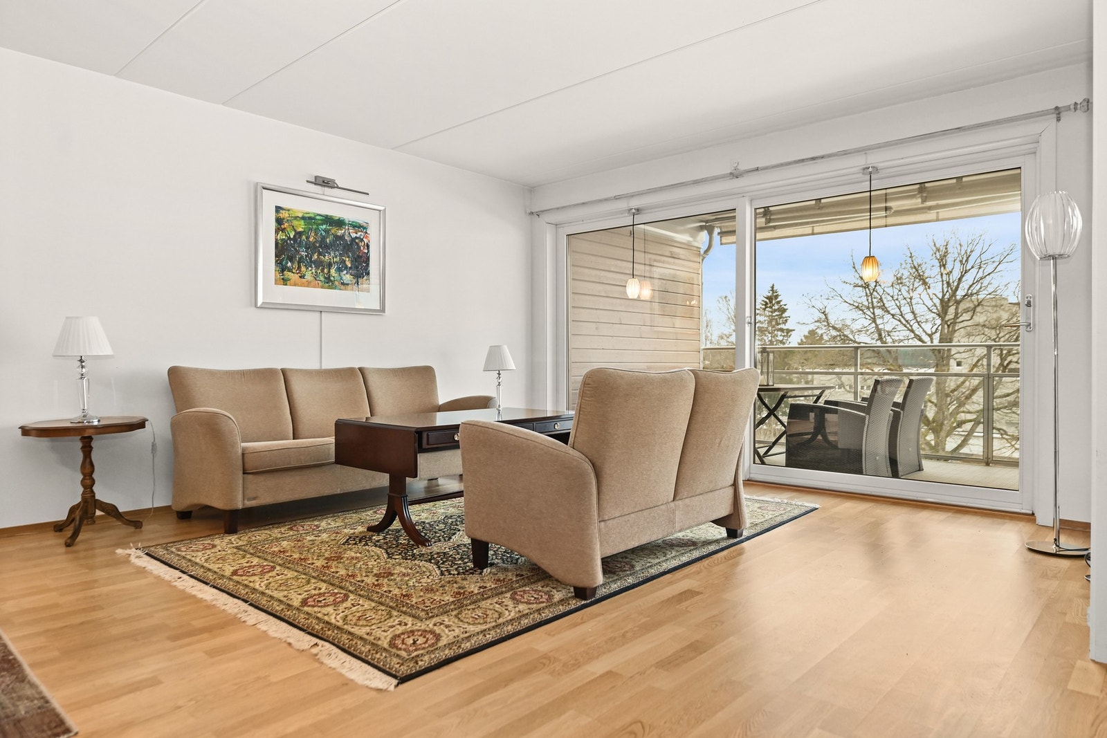 Stue med lysmalte vegger og store vinduer som gir godt med naturlig lysinnslipp. Galleribilde