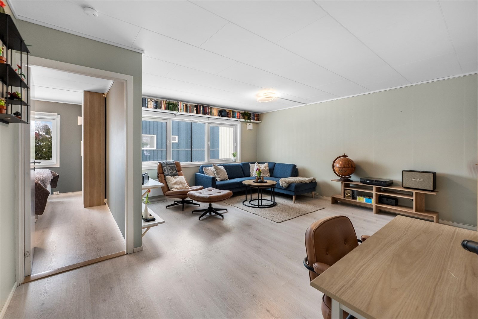 Lys og romslig stue med store vindusflater som åpner rommet. Galleribilde