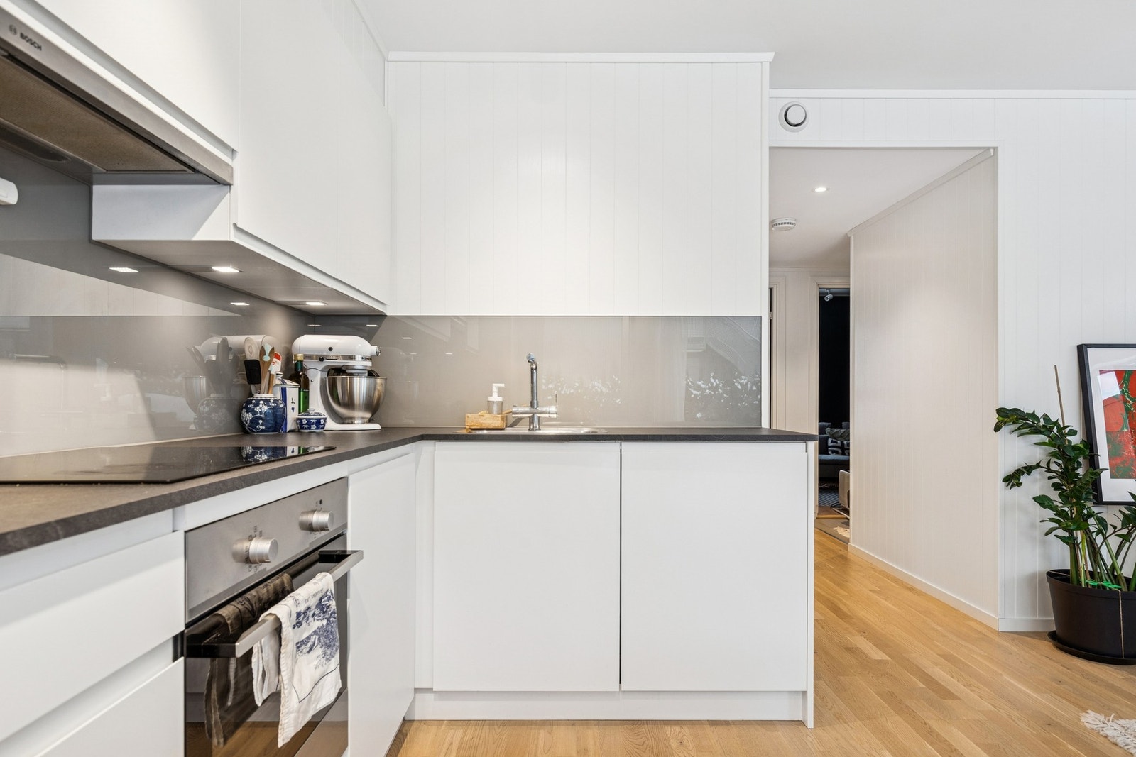 Kjøkkenet har hvite, slette fronter med laminat benkeplate og "grease guard". Galleribilde