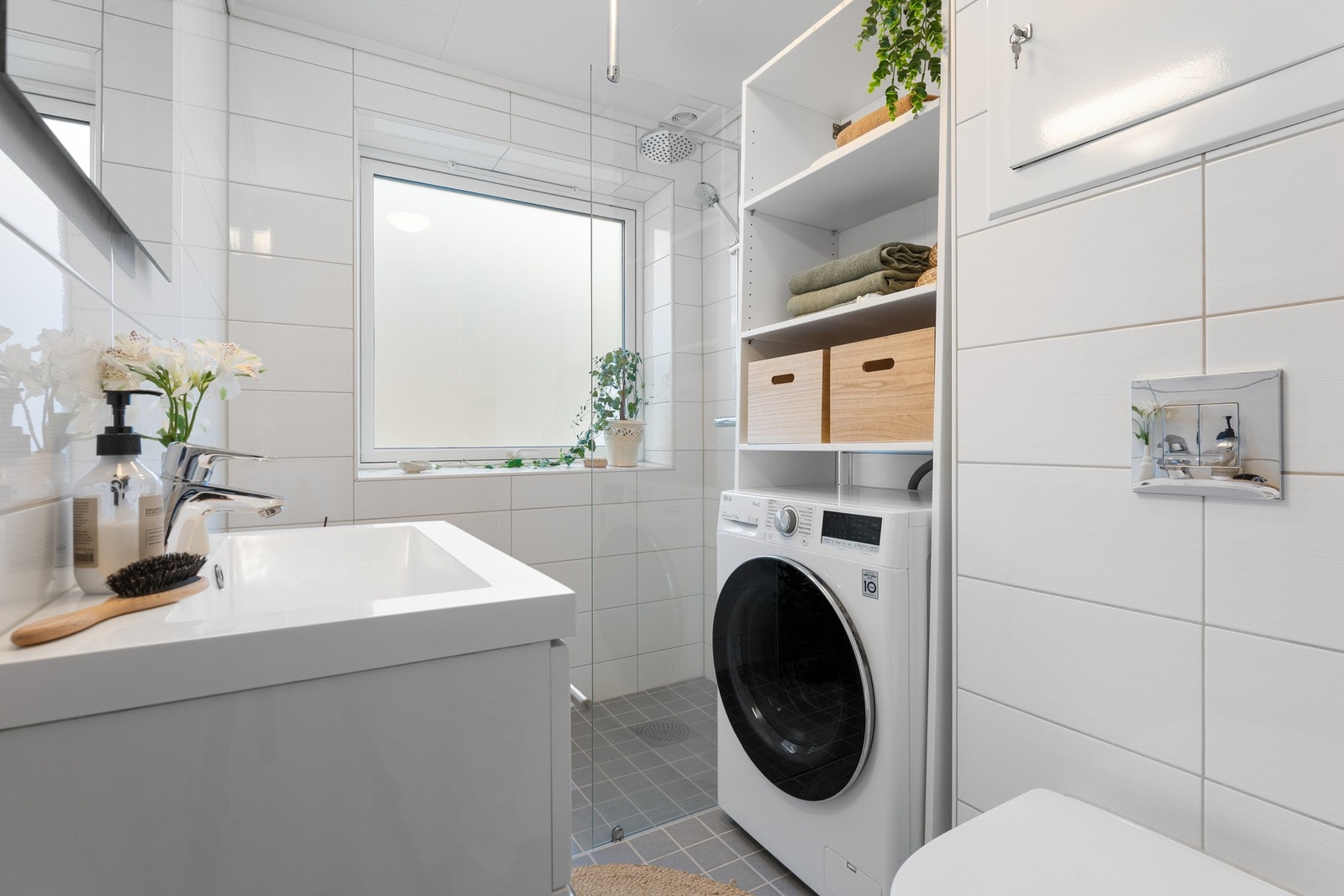 - Badet er helfliset og lyst, med vegghengt toalett, dusjvegger i glass og servant med benkeskap - Galleribilde