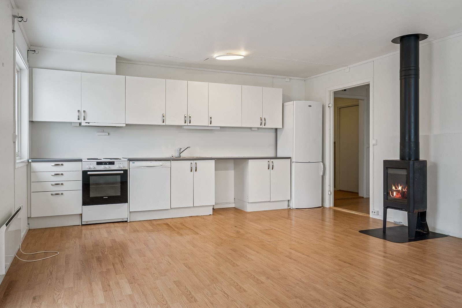 Vedovnen i stuen gir en effektiv og lun varmekilde på kalde dager. Galleribilde