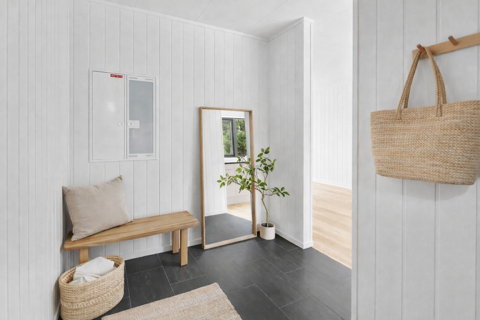 Inne i boligen blir du møtt av en lys entré med varme i gulvet og plass til yttertøy og sko. Bildet er redigert med KI. Galleribilde