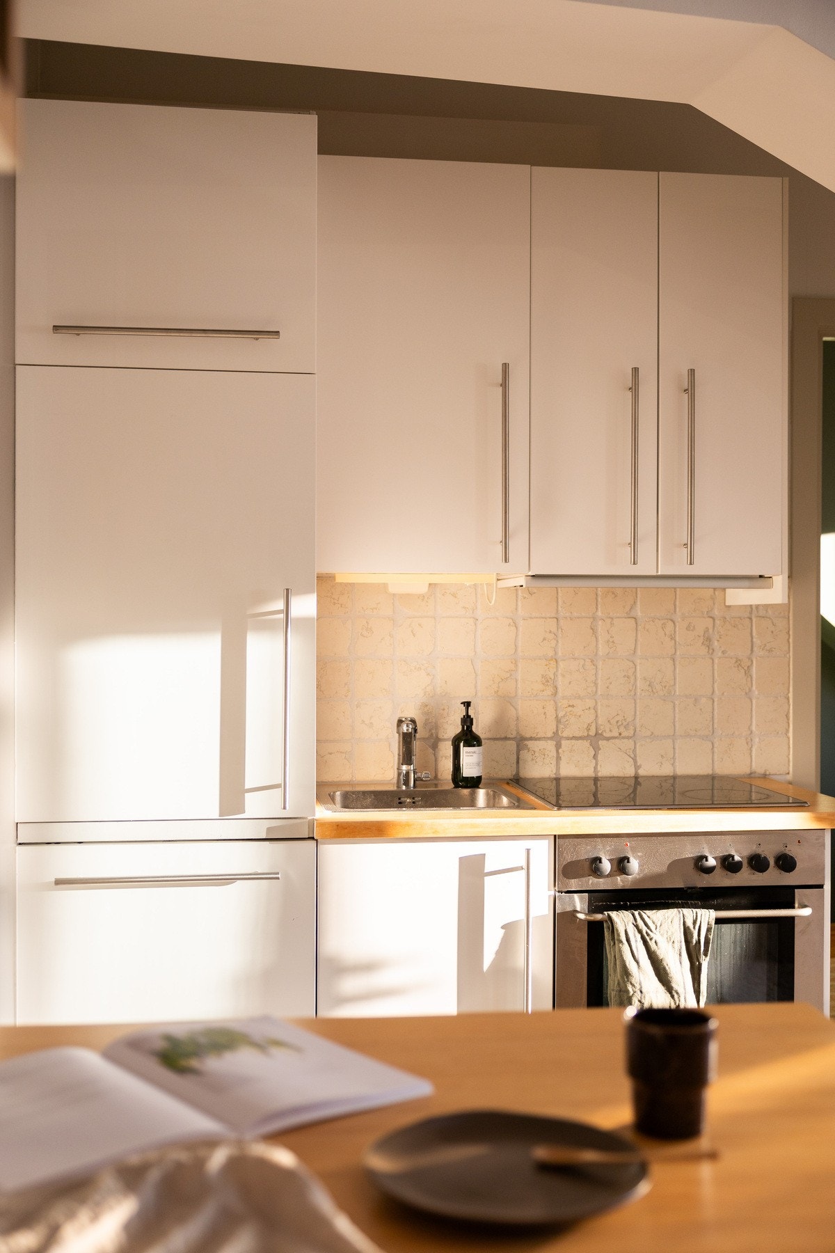 Innredningen har slette fronter, heltre benkeplate med nedfelt oppvaskkum av rustfritt stål. Galleribilde