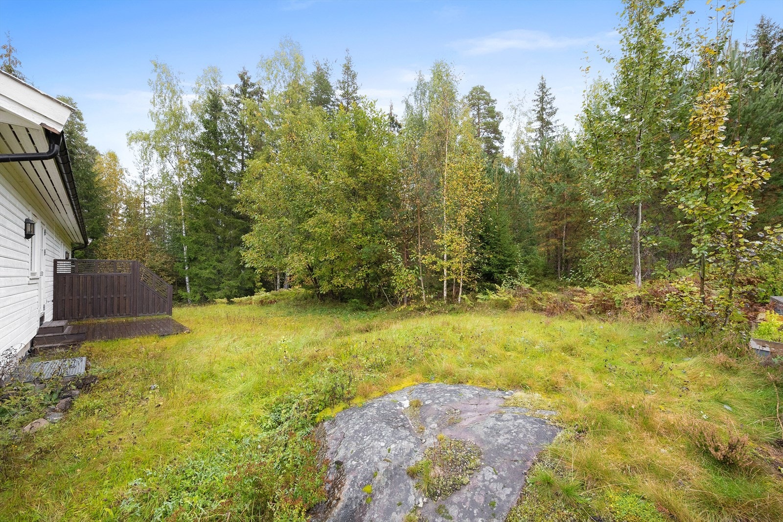 Tomten er opparbeidet med plen og grenser mot et grøntareal. Galleribilde