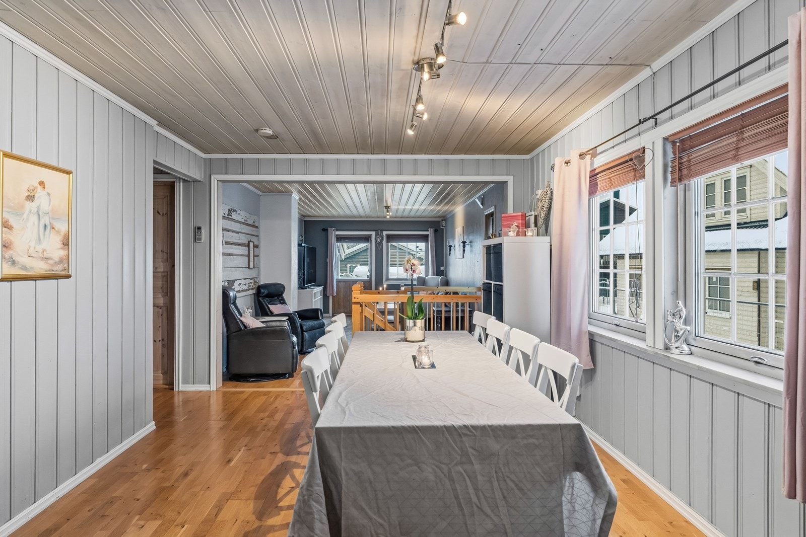 Spisestue og stue i åpen løsning. Det er montert persienner på vinduene. Galleribilde