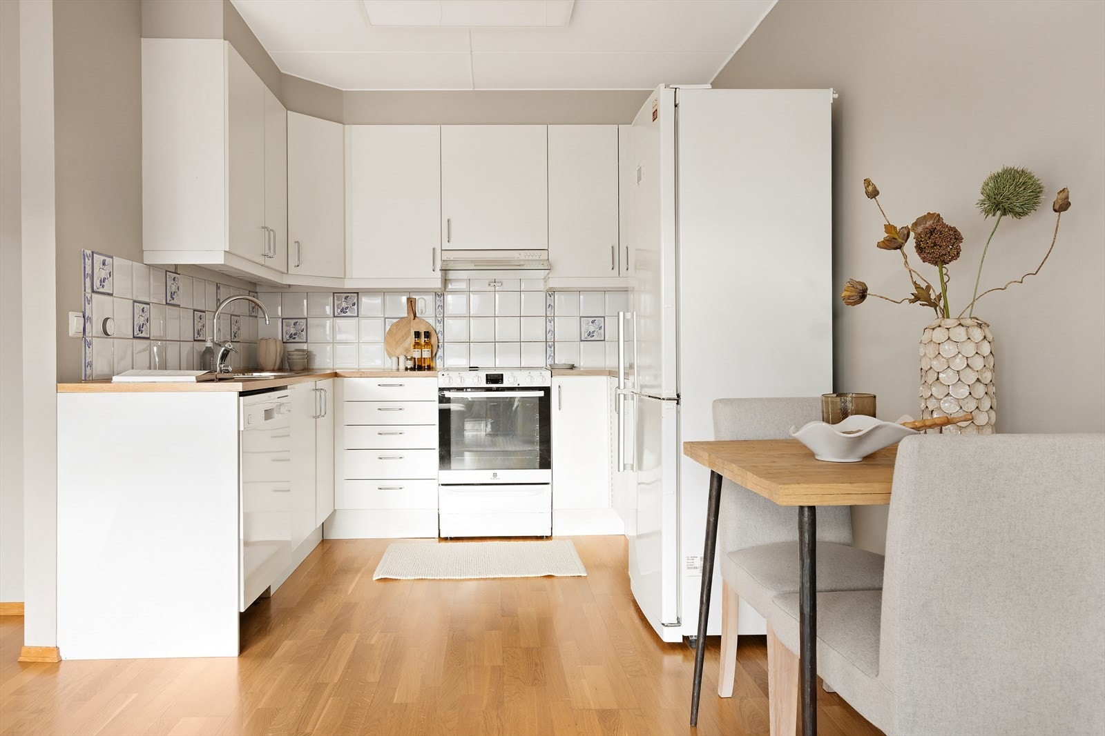 Kjøkkeninnredningen har hvite, glatte fronter og benkeplate i trelaminat. Galleribilde