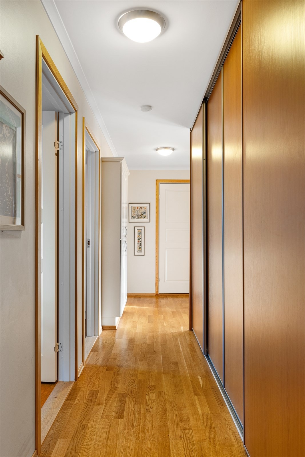 Praktisk og romslig soveromsgang med en smart skyvedørsgarderobe som gir rikelig med oppbevaringsplass. En funksjonell løsning som holder gangen ryddig og organisert, samtidig som den gir enkel tilgang til klær og tilbehør. Galleribilde