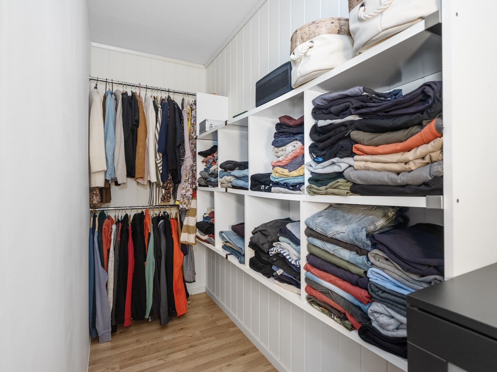 Romslig walk-in closet med god plass til klær og tilbehør Galleribilde