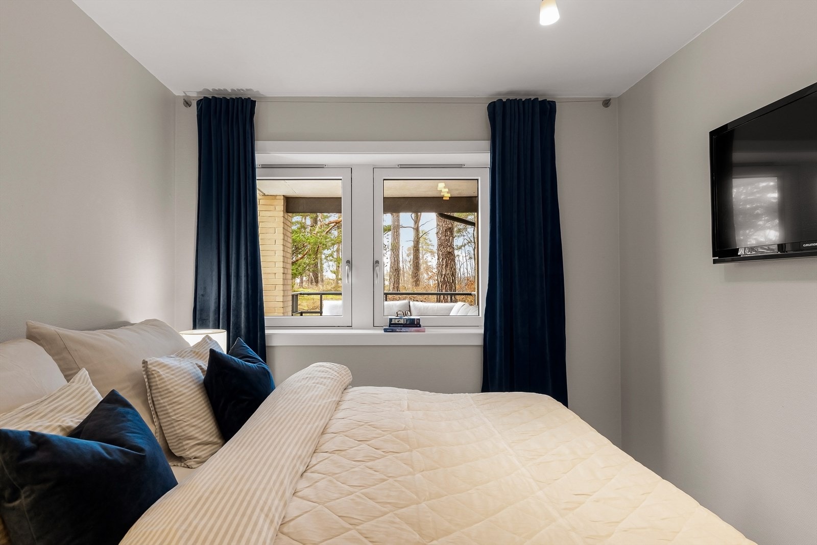 Lyst og innbydende soverom med lysinnslipp fra to vinduer. Galleribilde