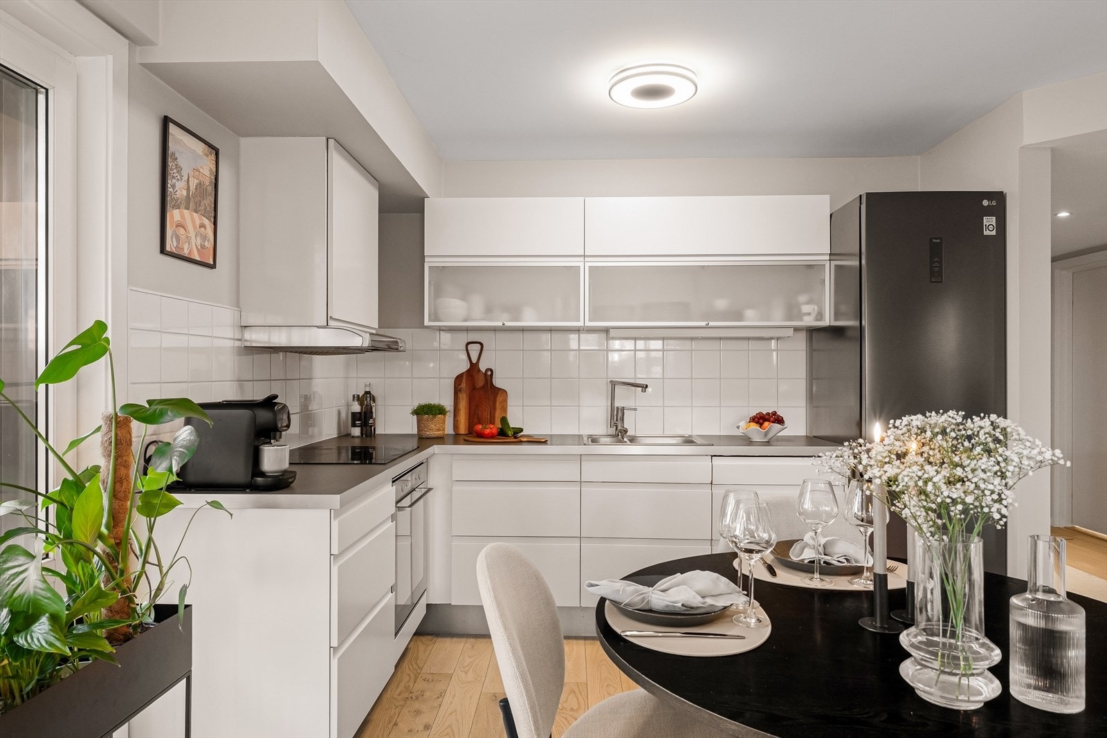 Lyst kjøkken med glatte fronter og laminat benkeplate. Galleribilde