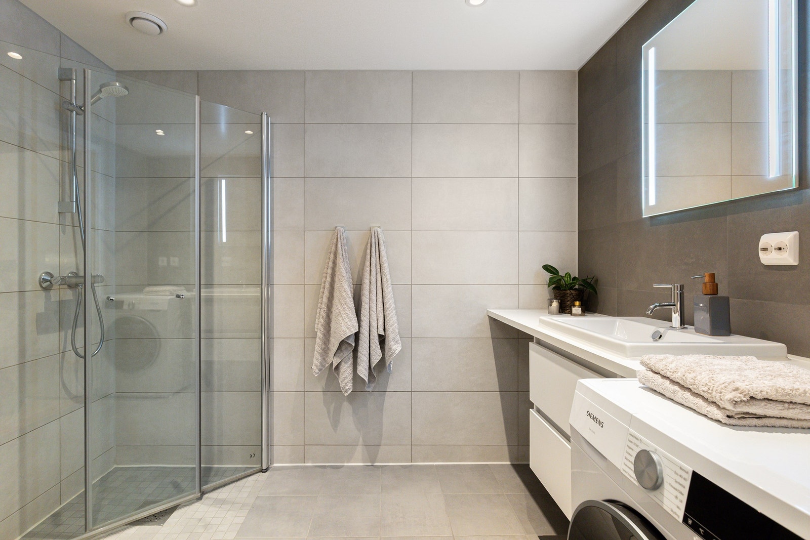 Delikat og romslig baderom med tidløse fliser og gulvvarme. Galleribilde