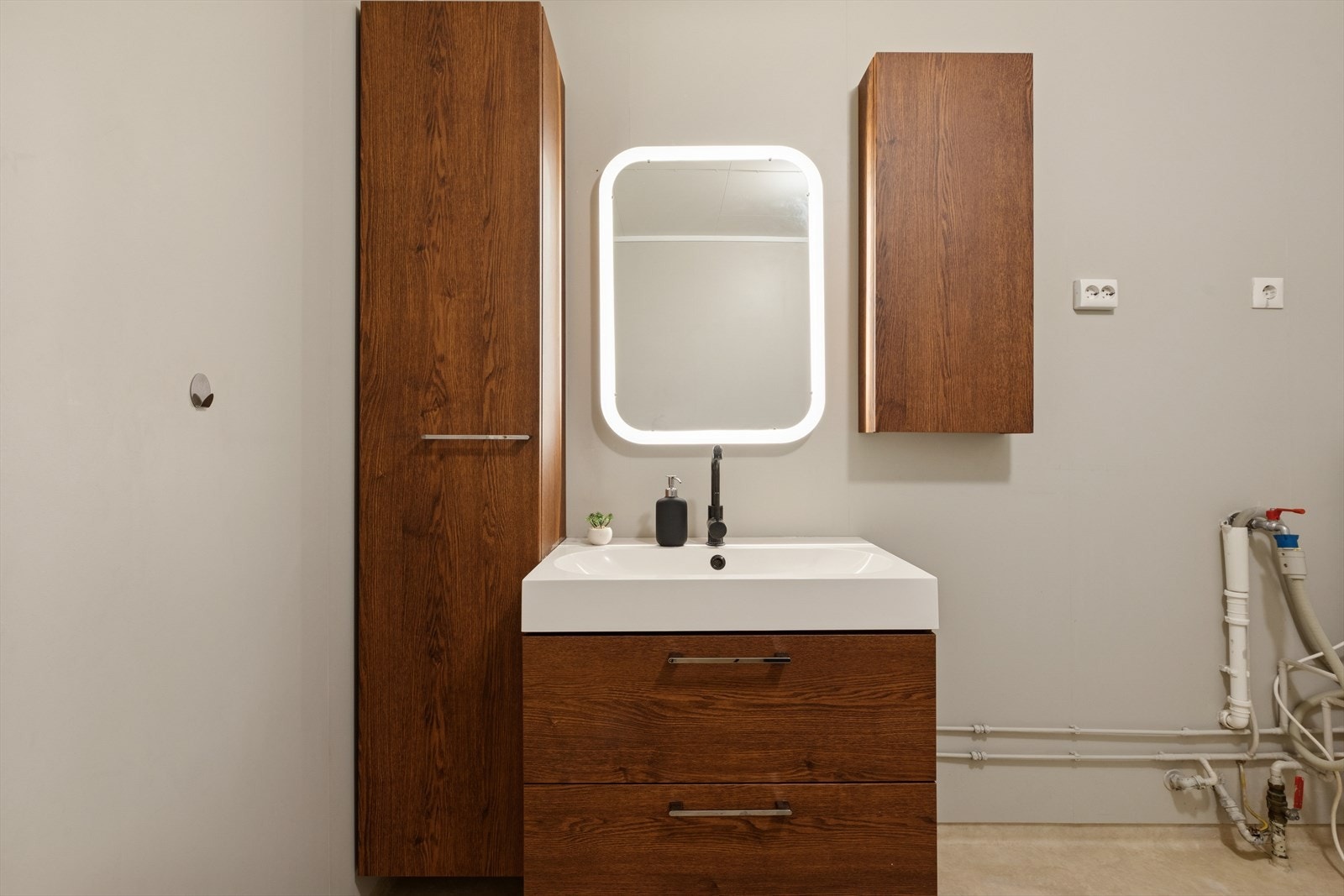 Baderomsinnredningen med servant, speil og høyskap ble fornyet i 2022. Galleribilde