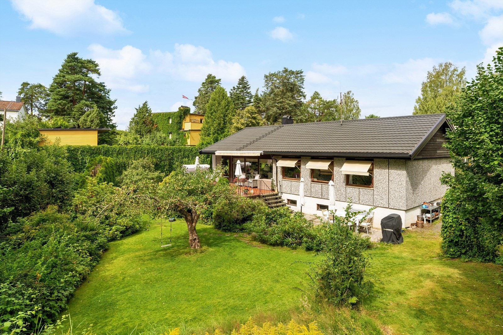 Grønn og idyllisk uteplass med en lun, skjermet atmosfære. Her vil dere trives! Galleribilde