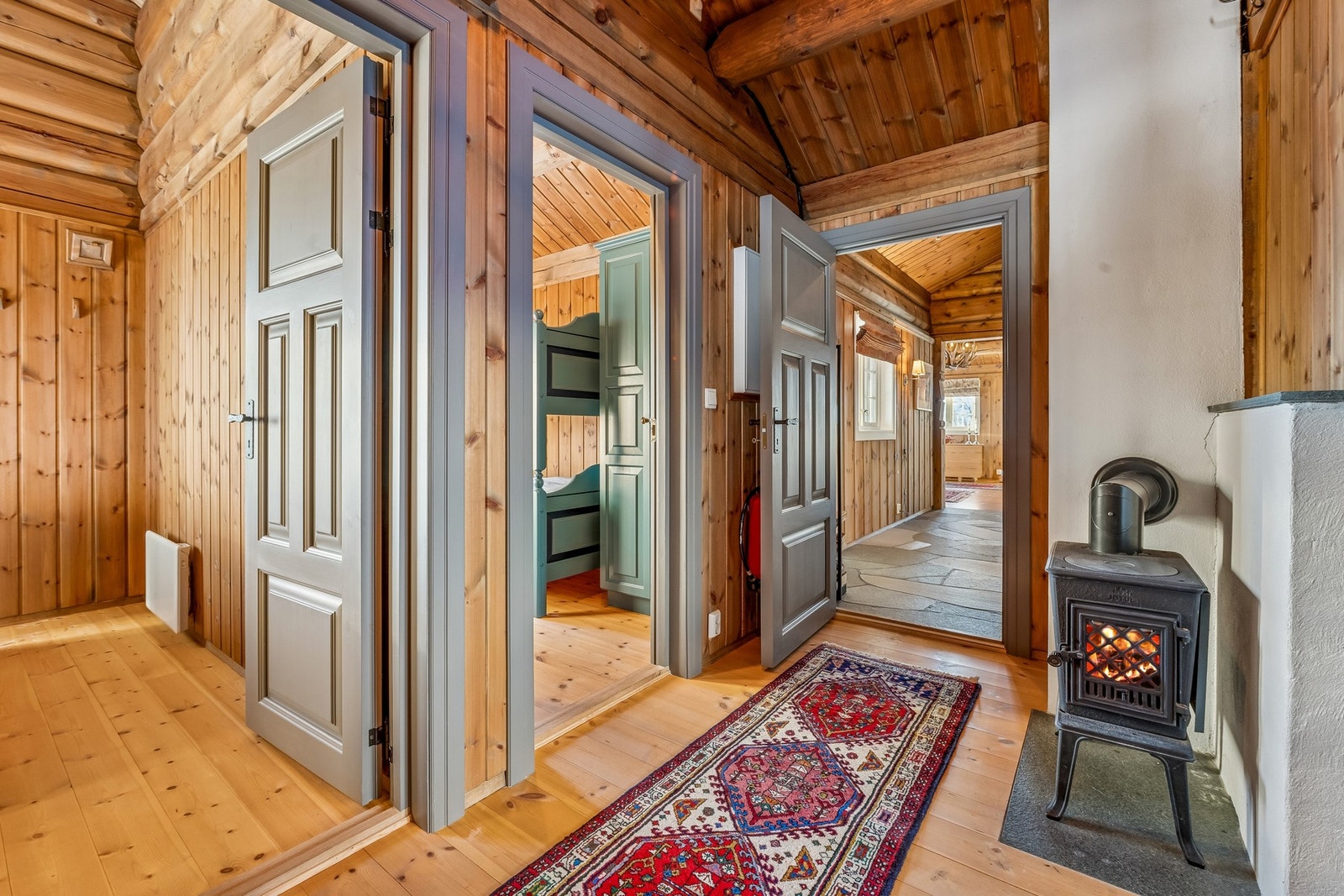 Entreen utenfor de fire soverommene har egen vedovn som sikrer god varme på kalde dager Galleribilde