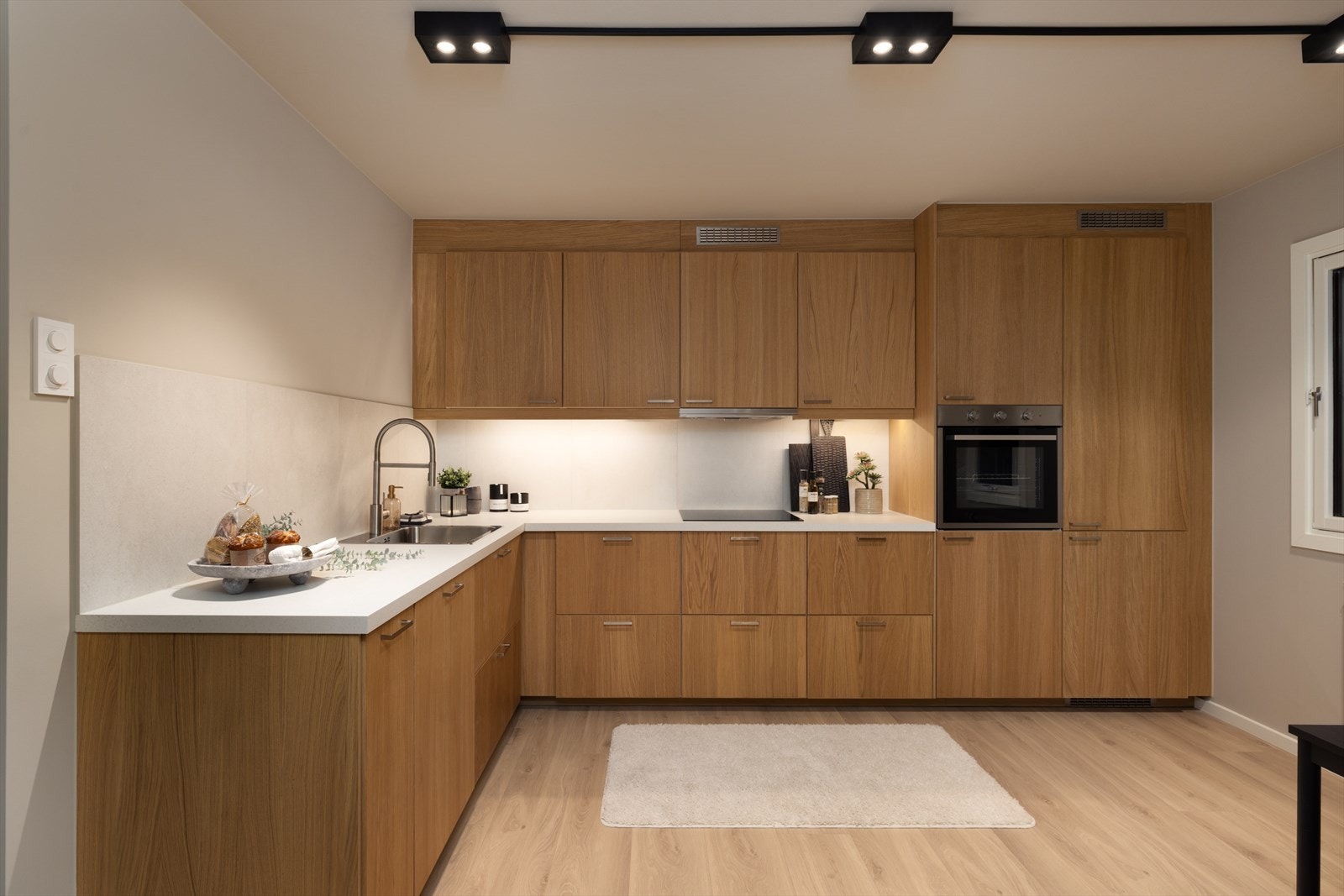 Lekkert kjøkken fra 2026 med slette fronter og en laminert benkeplate med nedfelt vaskekum. Galleribilde