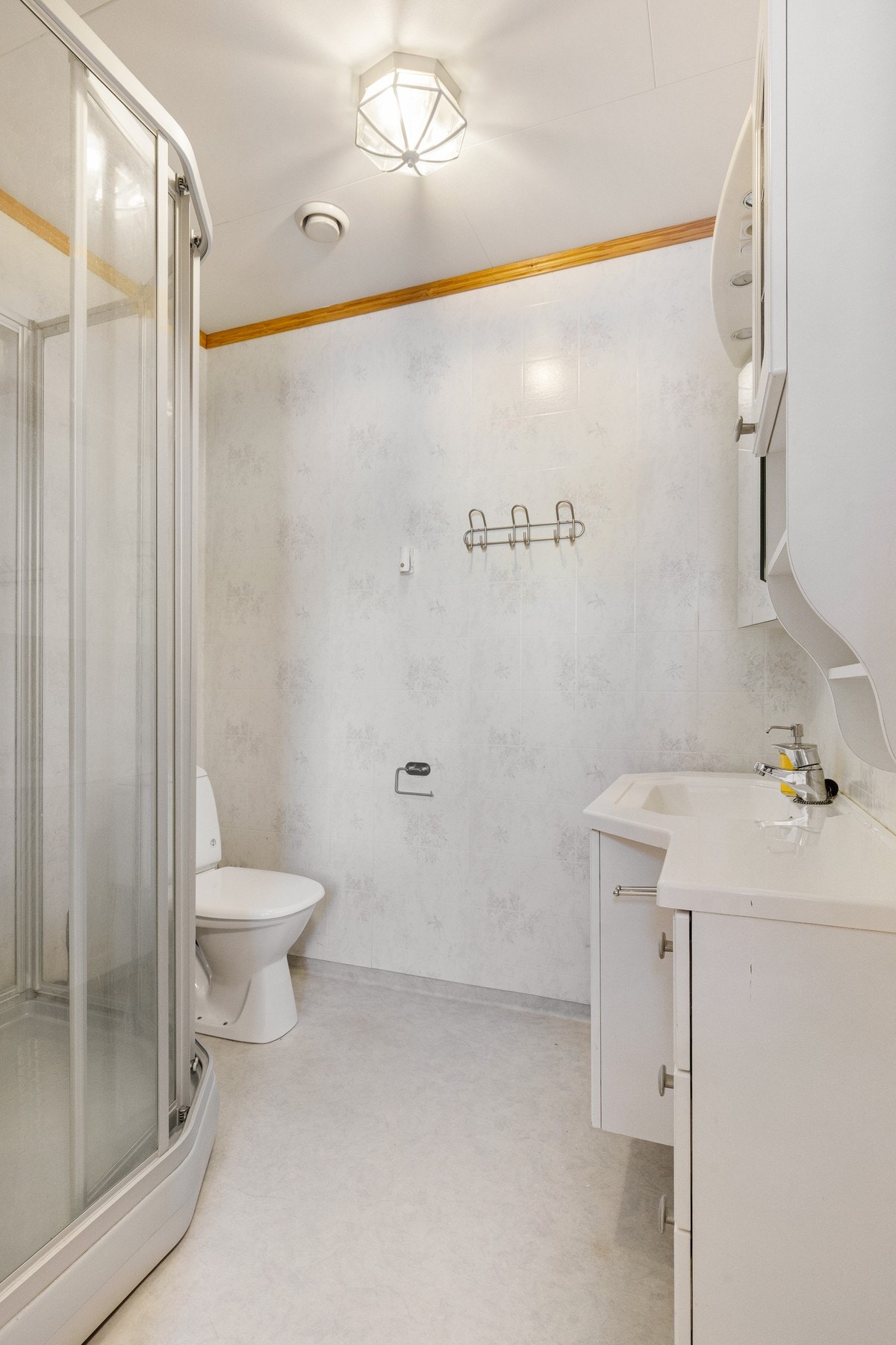 I tilknytning til vaskerommet finner du boligens andre baderom, bestående av servant med underskap, toalett og dusjkabinett Galleribilde