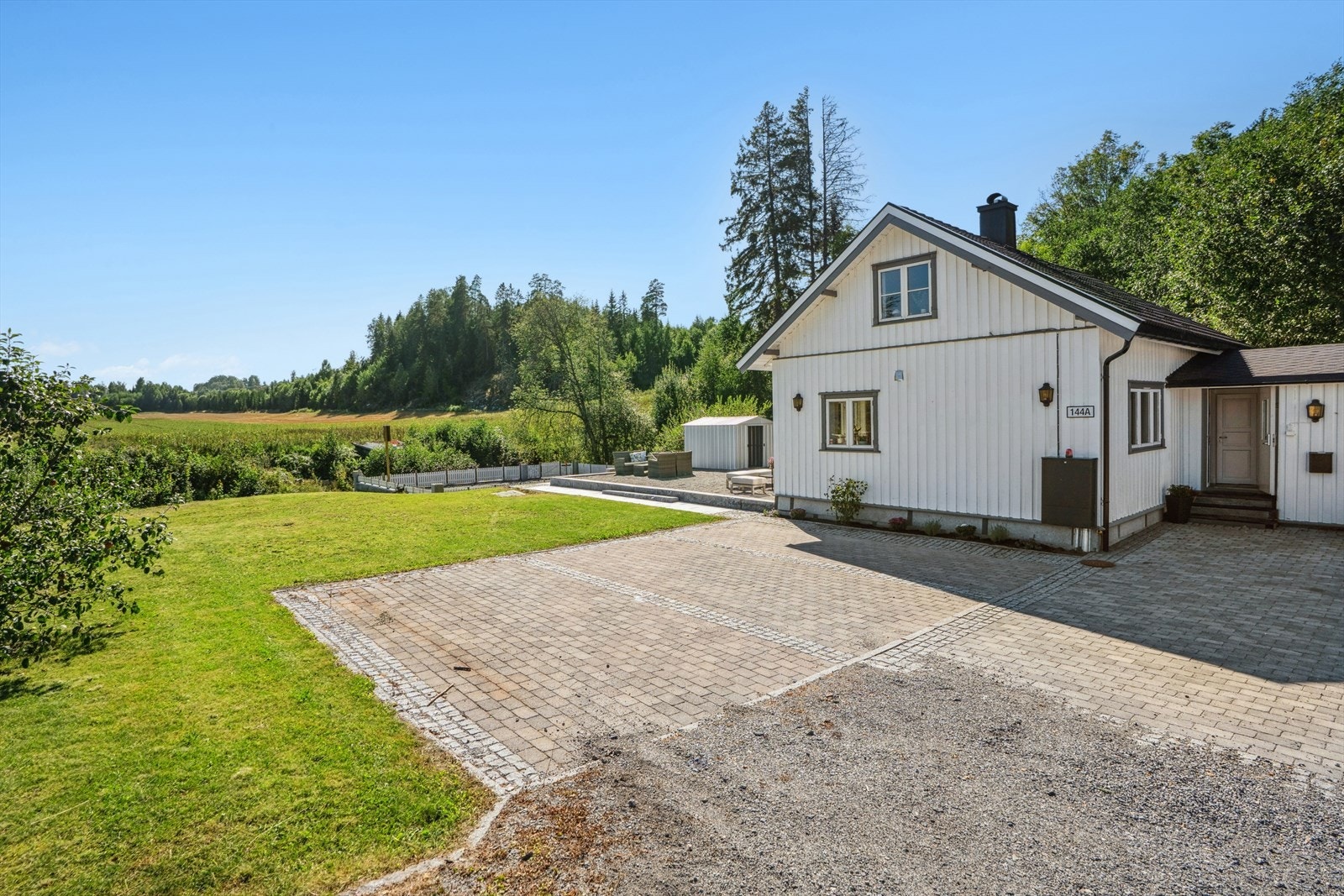 Steinlagt biloppstillingsplass med plass til flere biler Galleribilde