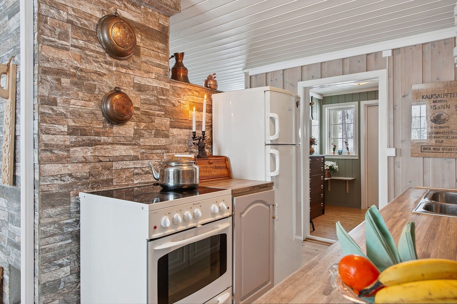 Kjøkkenet er utstyrt med frittstående komfyr og kjøleskap som medfølger i salget. Galleribilde