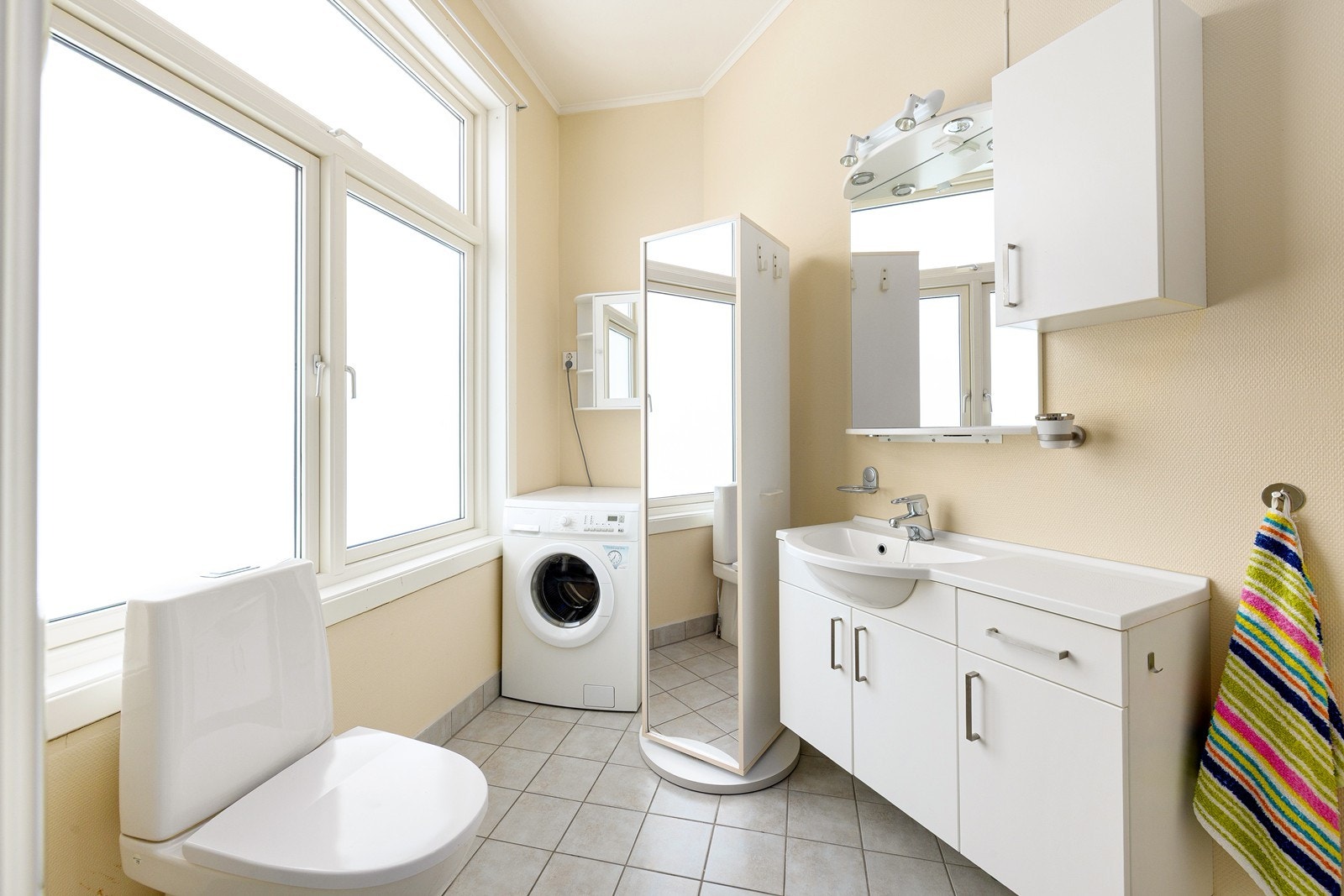 Rommet er utstyrt med en skapinnredning med servant, toalett, dusjkabinett og opplegg for vaskemaskin. Galleribilde