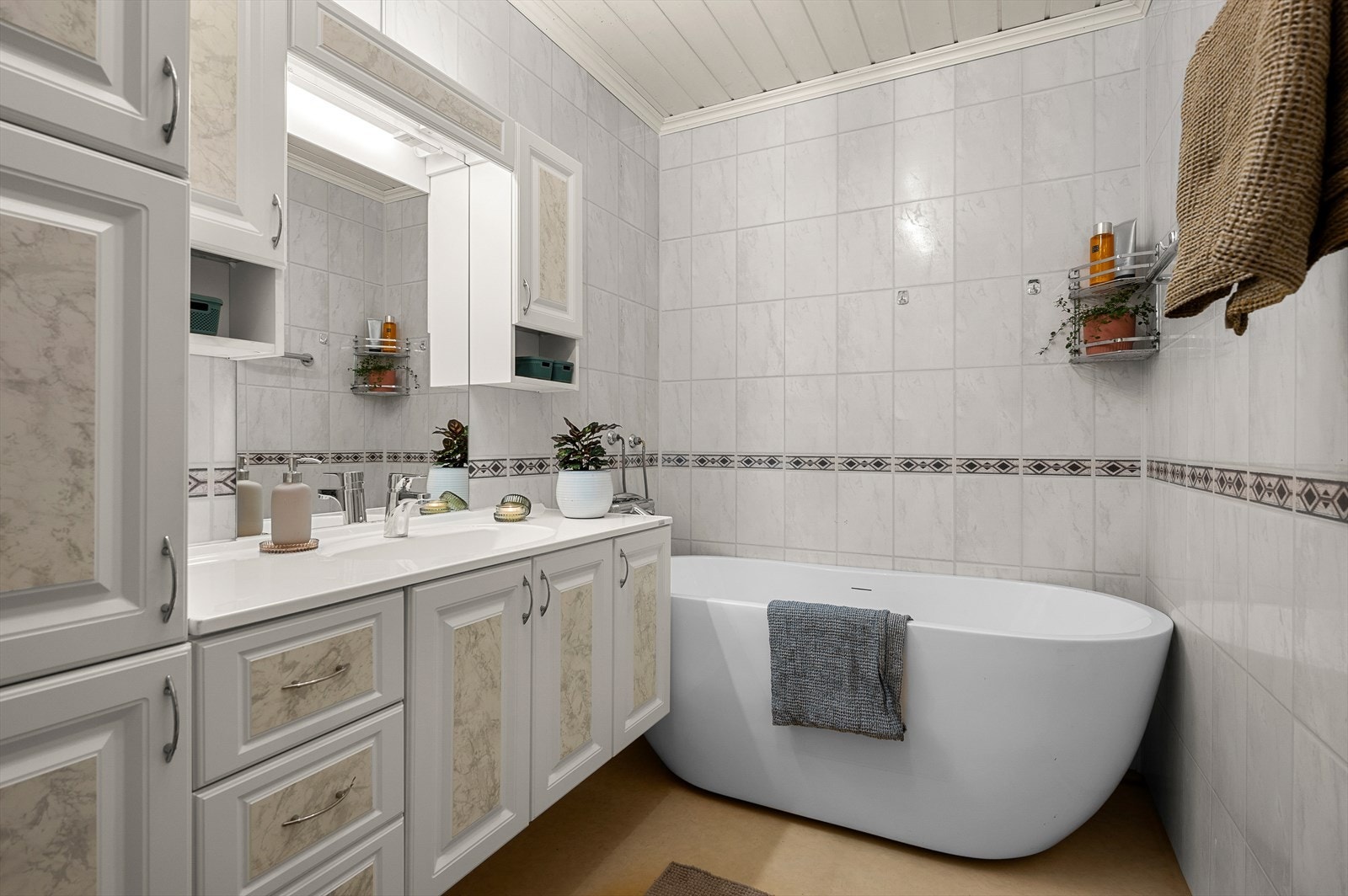 Bad med behagelig gulvvarme, badekar og mye lagringsplass Galleribilde