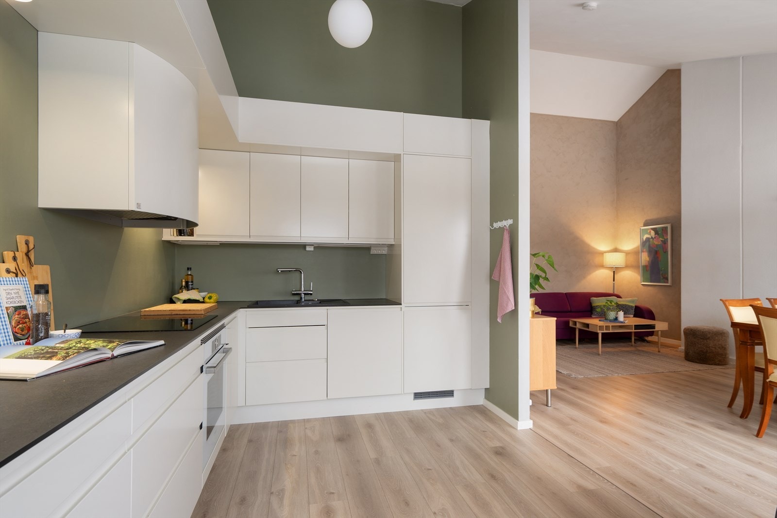 Åpen løsning mellom kjøkken og stue gir en naturlig overgang mellom sonene. Galleribilde