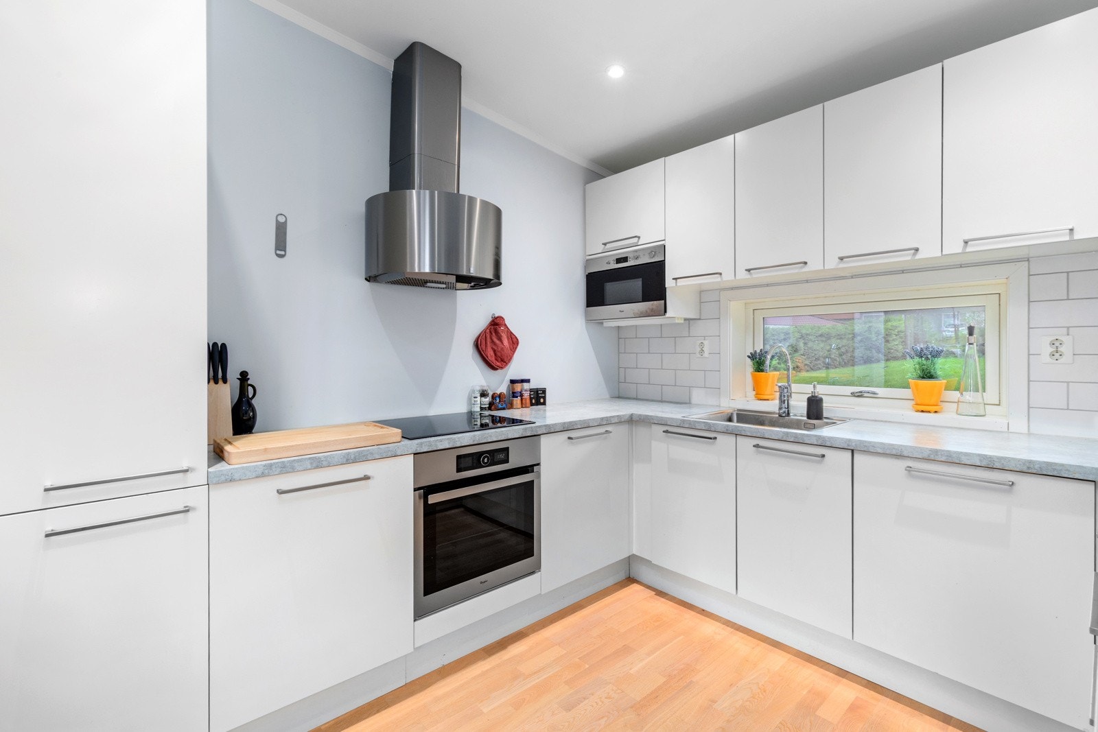 På kjøkkenet er det integrert kjøle/fryseskap, stekeovn, induksjonstopp, mikrobølgeovn og oppvaskmaskin Galleribilde