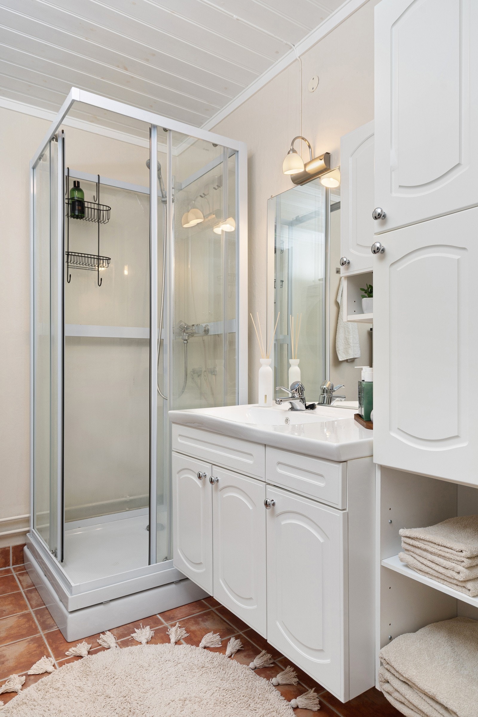 Sideskap og underskap under servant gir godt med oppbevaring for håndklær og toalettartikler Galleribilde