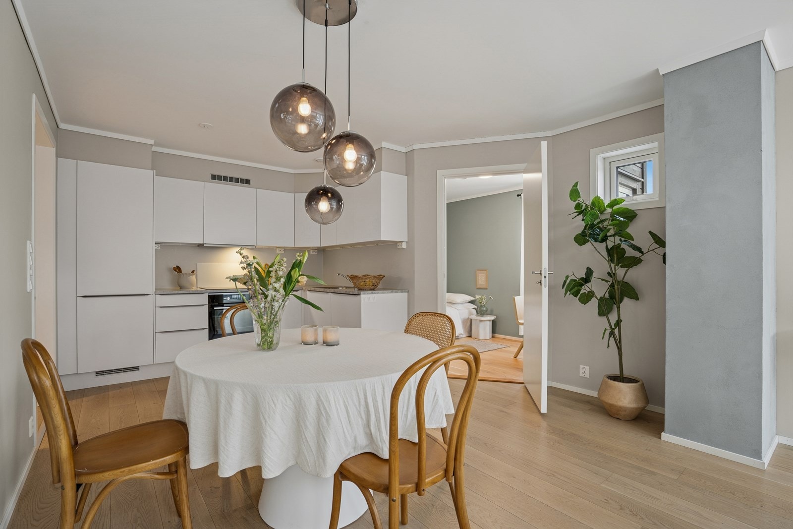 Oppholdsrommet har en åpen og moderne løsning mellom stue og kjøkken, som gir en lys og sosial atmosfære. Her er det plass til både spisebord og sofagruppe. Galleribilde