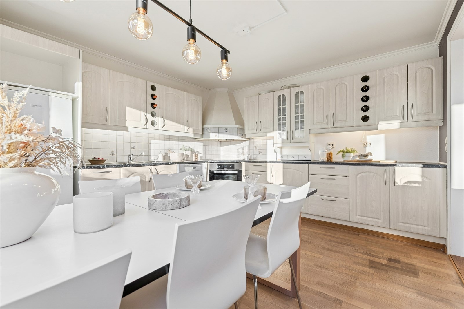 Stort kjøkken med rikelig benke og skapplass. Det er også plass til et stort spisebord på kjøkkenet. Galleribilde