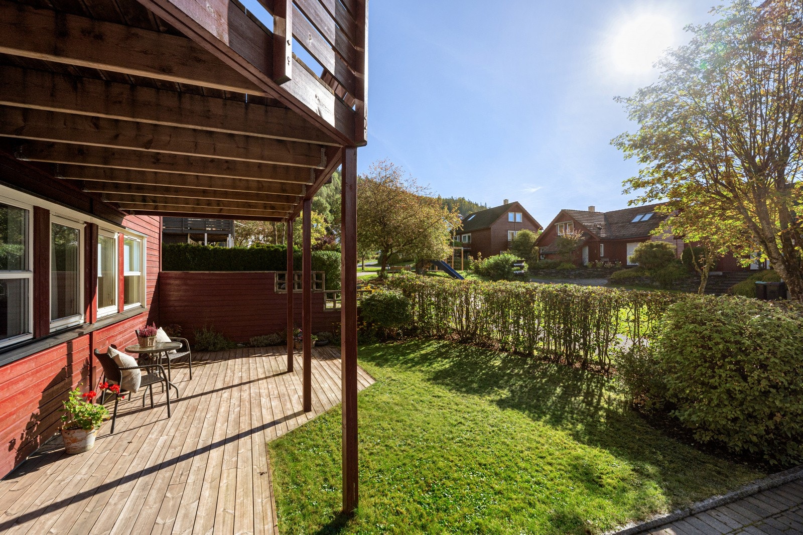 På bakkeplan finner du en markterrasse ved inngangspartiet, perfekt for morgenkaffen eller et lunt oppholdssted i le for vinden. Fra denne sonen leder en trapp videre opp til en egen markterrasse og plenareal på baksiden av boligen. Galleribilde