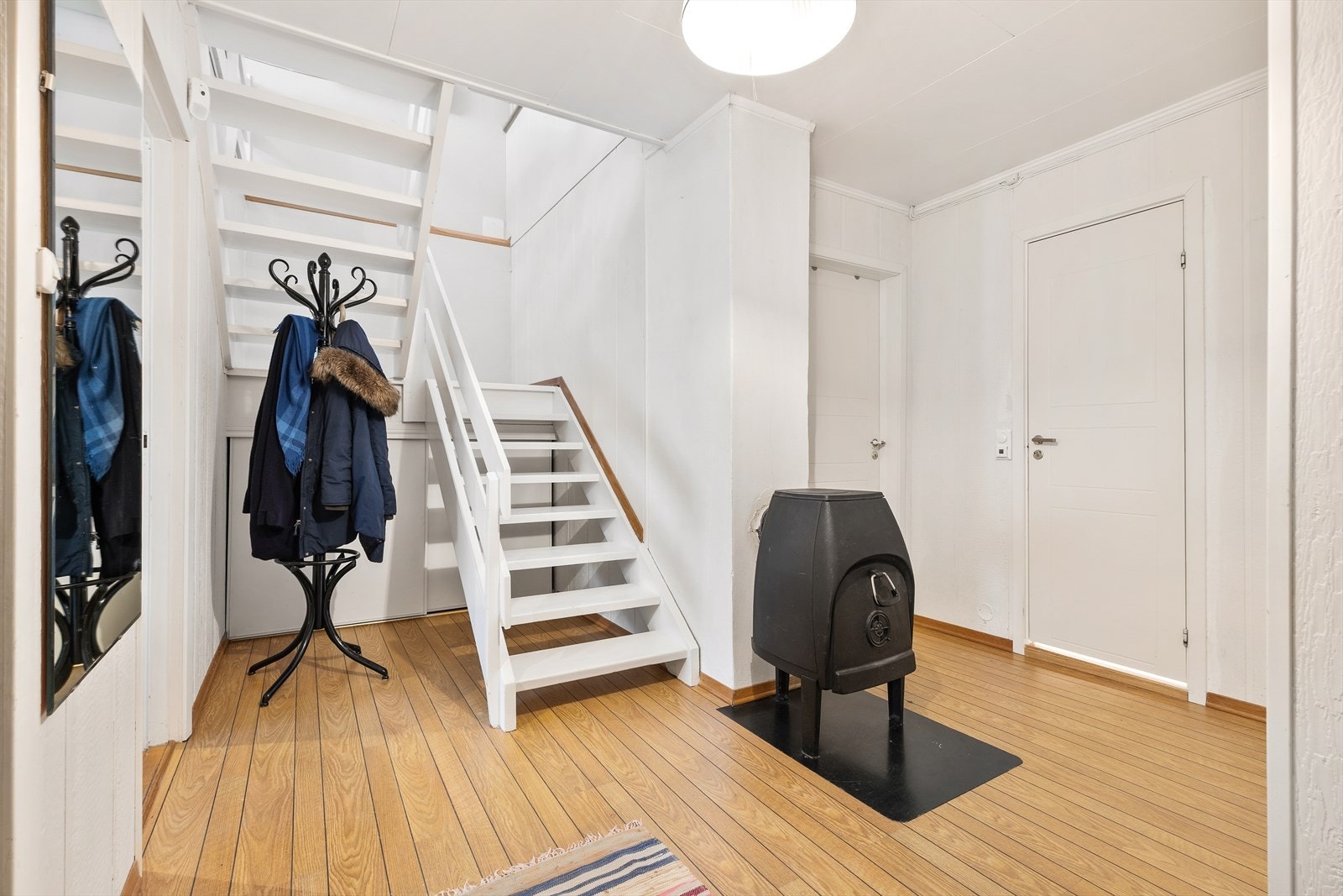 Den malte tretrappen med rekkverk av liggende bord forbinder de to etasjene. Galleribilde