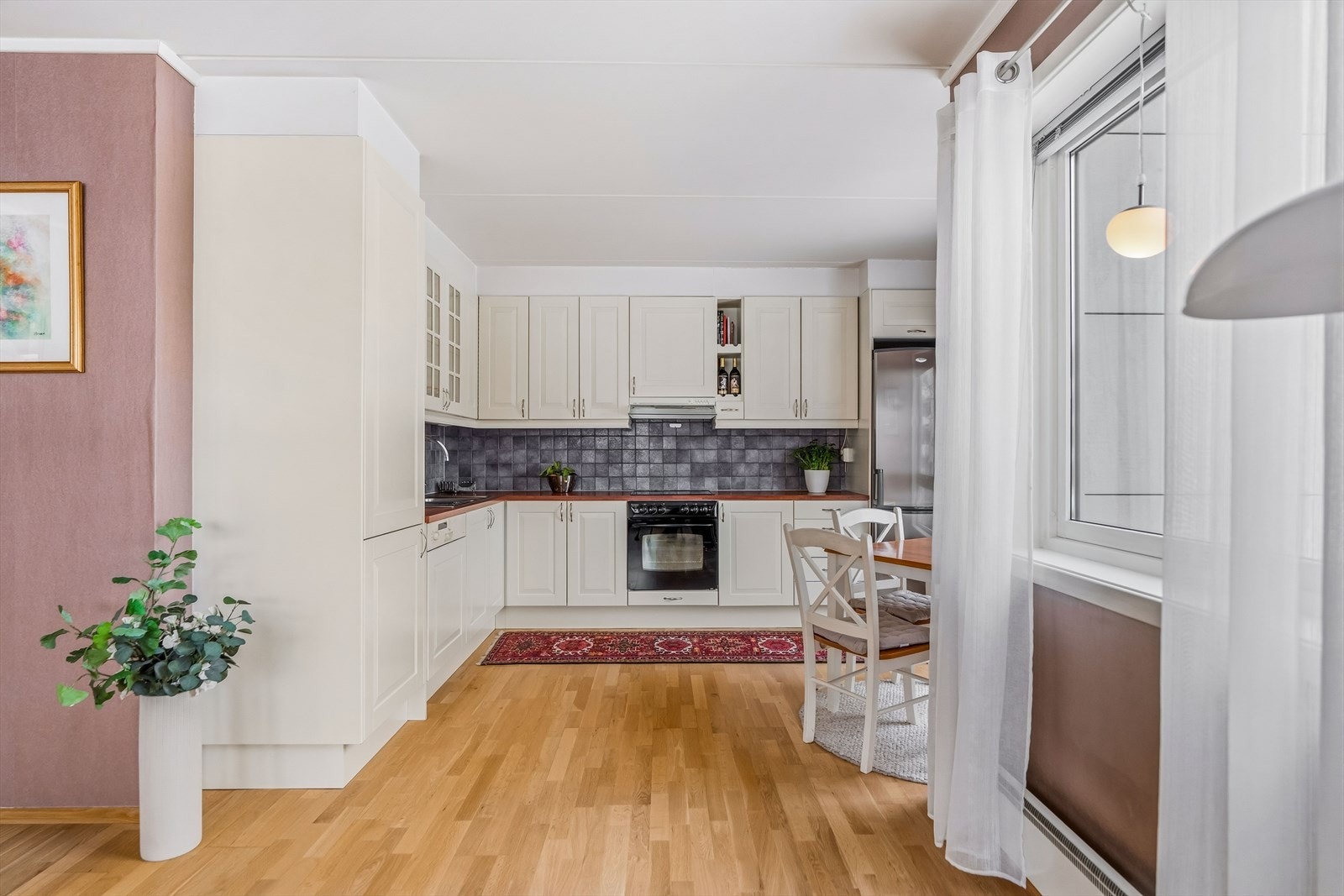 Kjøkkeninnredningen har profilerte fronter, samt laminert benkeplate med nedfelt oppvaskkum og 1-greps blandebatteri. Galleribilde