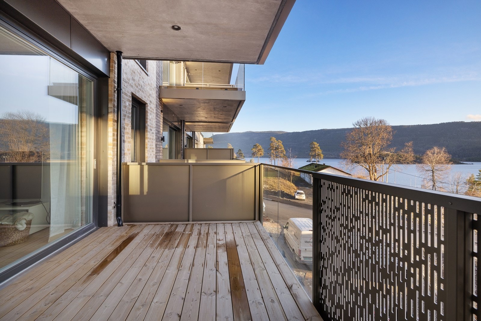 Terrassen utenfor stuen er bygget med terrassebord og har rekkverk i metall og glass. Galleribilde