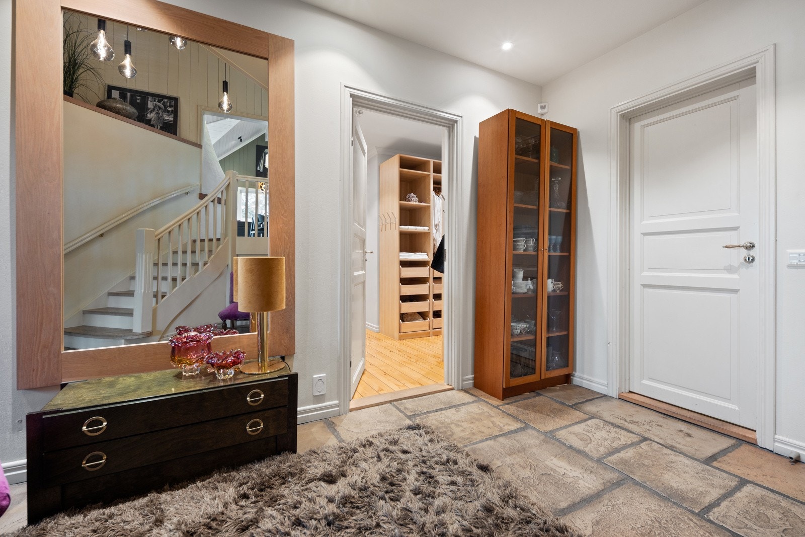 Fra hallen i 1. etasje er det tilgang til hovedsoverommet med tilhørende omkledningsrom og bad med badstue Galleribilde