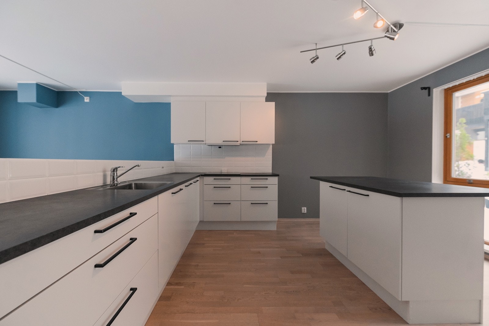 Pent og praktisk kjøkken med delvis åpen løsning mot stuen som gir rikelig med lysinnslipp fra begge sider av leiligheten. Galleribilde