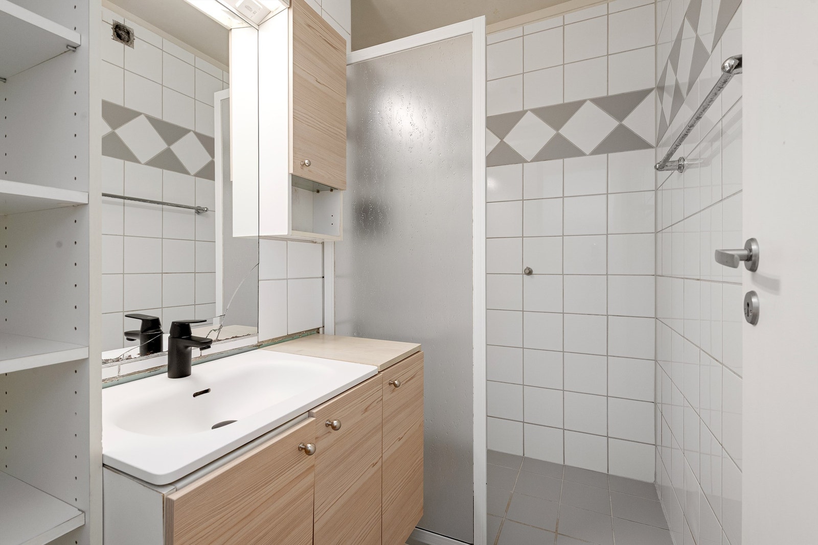 Flislagt bad med romslig innredning. Dusjhjørne med dør. Galleribilde