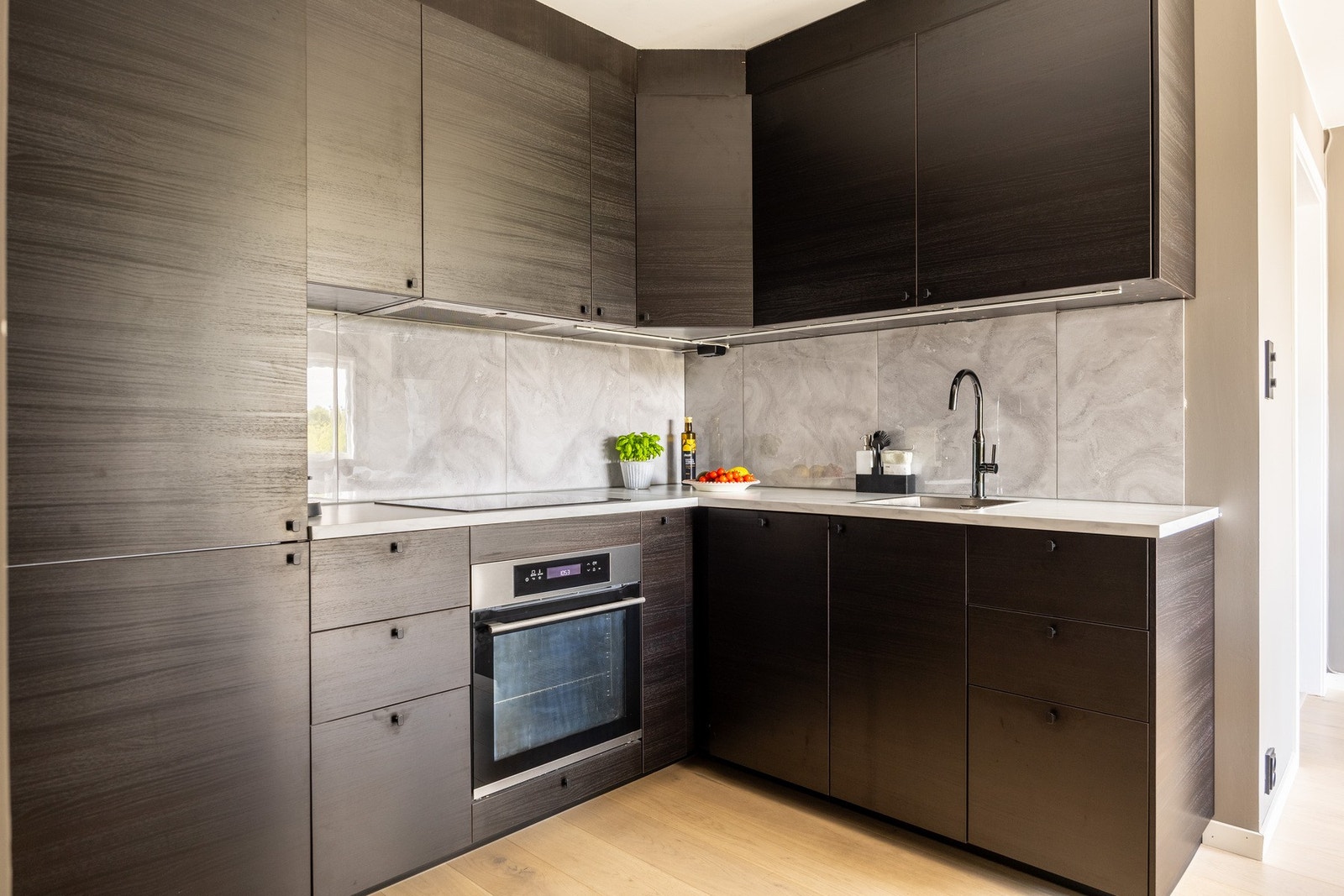 Moderne kjøkkeninnredning fra 2019 med slette overfalter. Godt med både skap- og benkeplass. Galleribilde