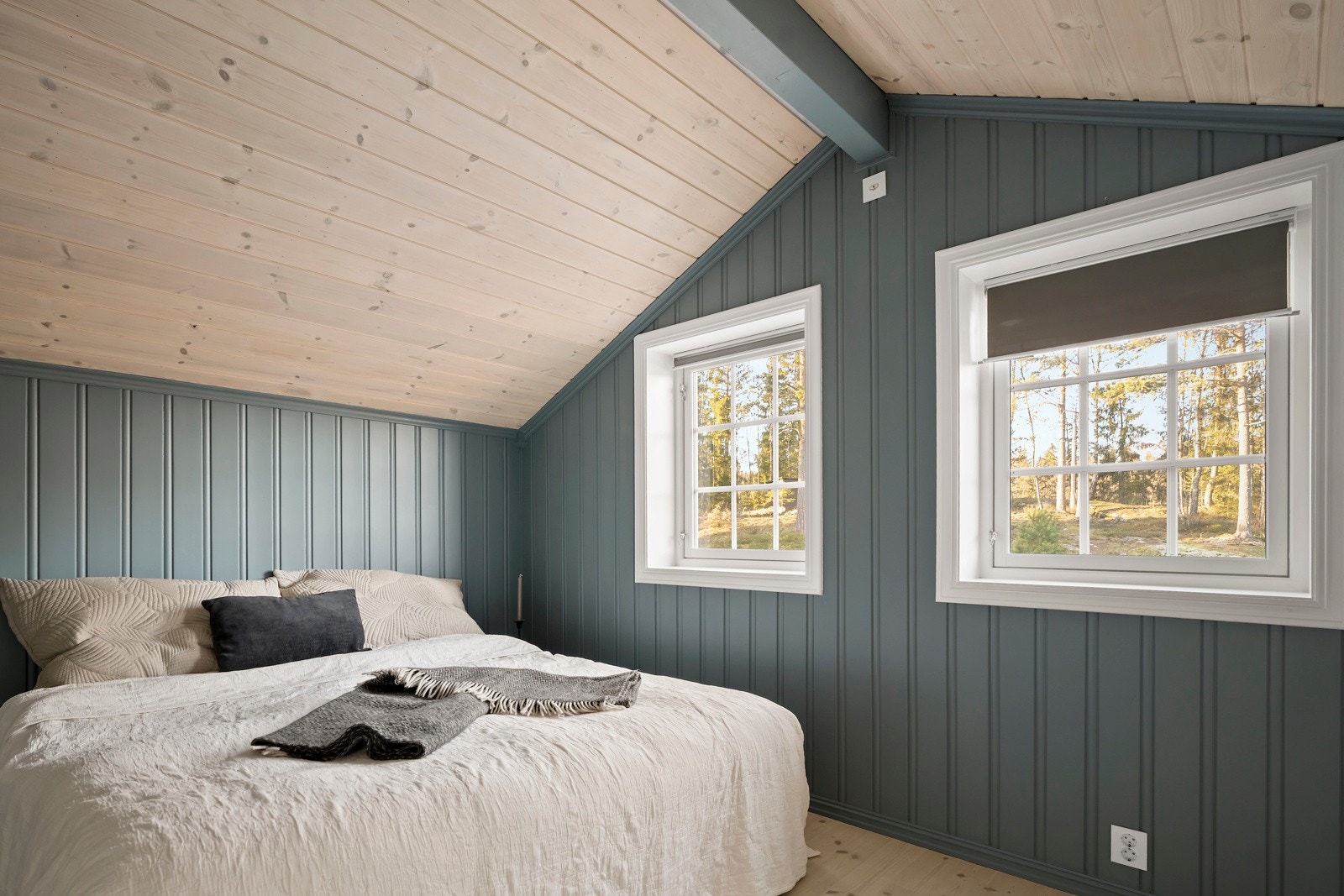 Soverommet i andre etasje har parkett på gulvet og er malt i en mørk, behagelig blåtone. Galleribilde