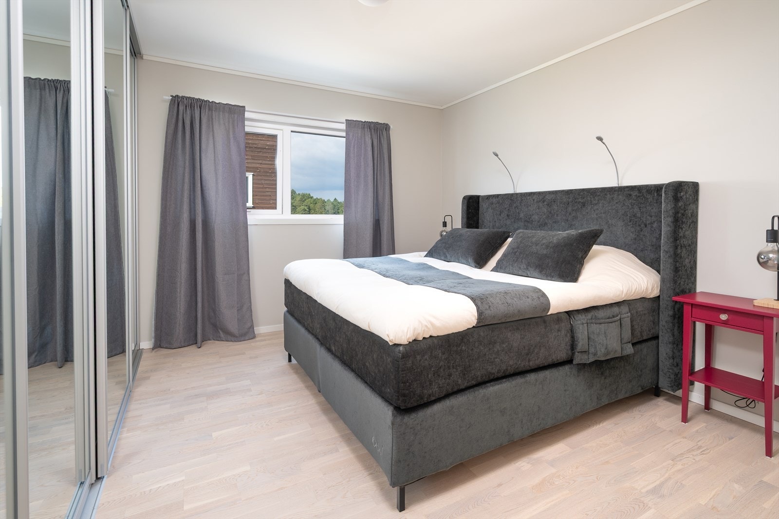 Romslig soverom med god plass til dobbelseng og romslig skapplass i medfølgende speilskyvedørsgarderobe Galleribilde