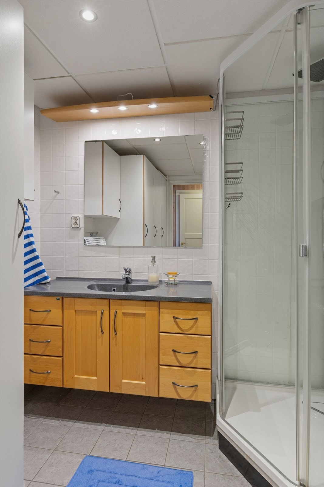 Det er god plass for oppbevaring på baderommet i underetasjen, og kjekt med en ekstra dusj i boligen. Galleribilde