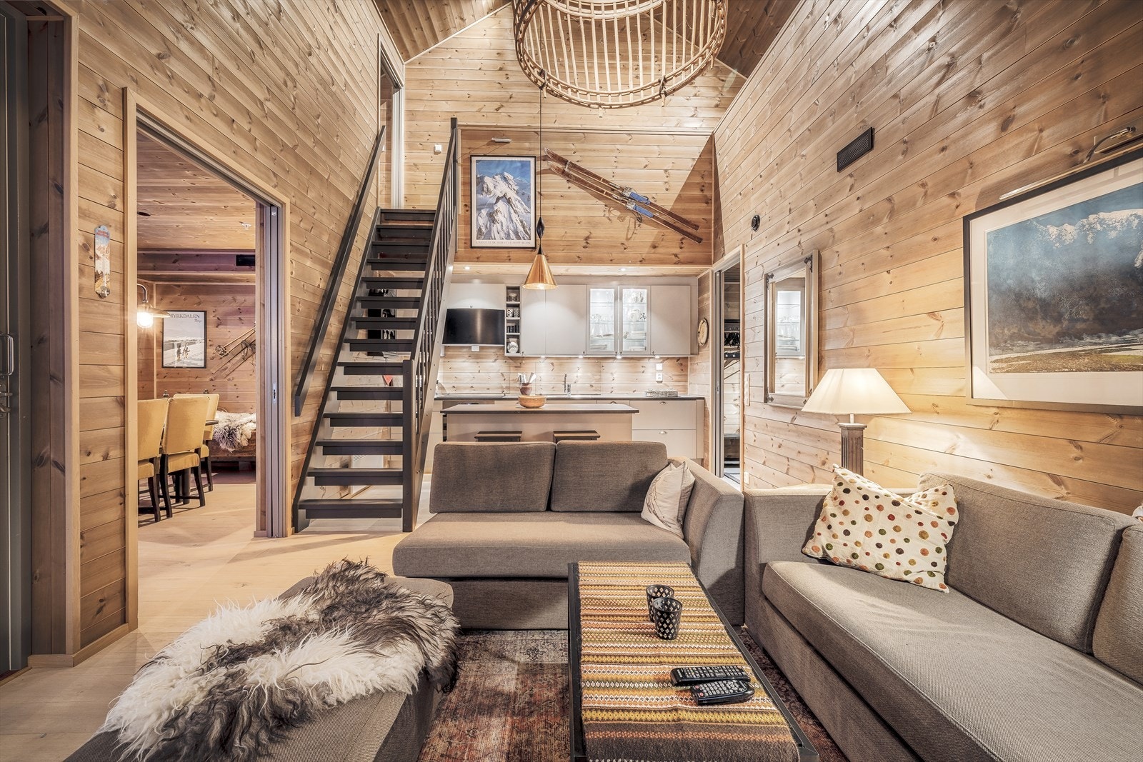 Lys og trivelig stue med parkettgulv og gjennomgående trepanel som skaper en varm atmosfære Galleribilde