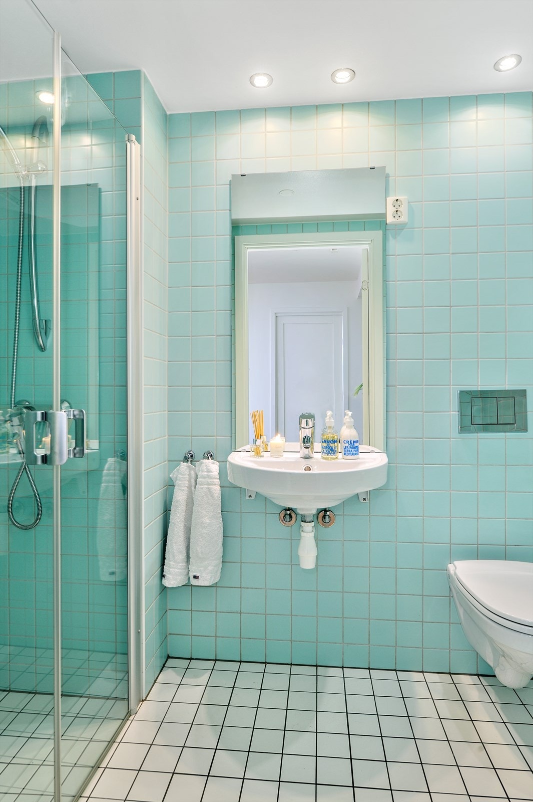 Flislagt gjestebad med praktisk dusjnisje. Galleribilde