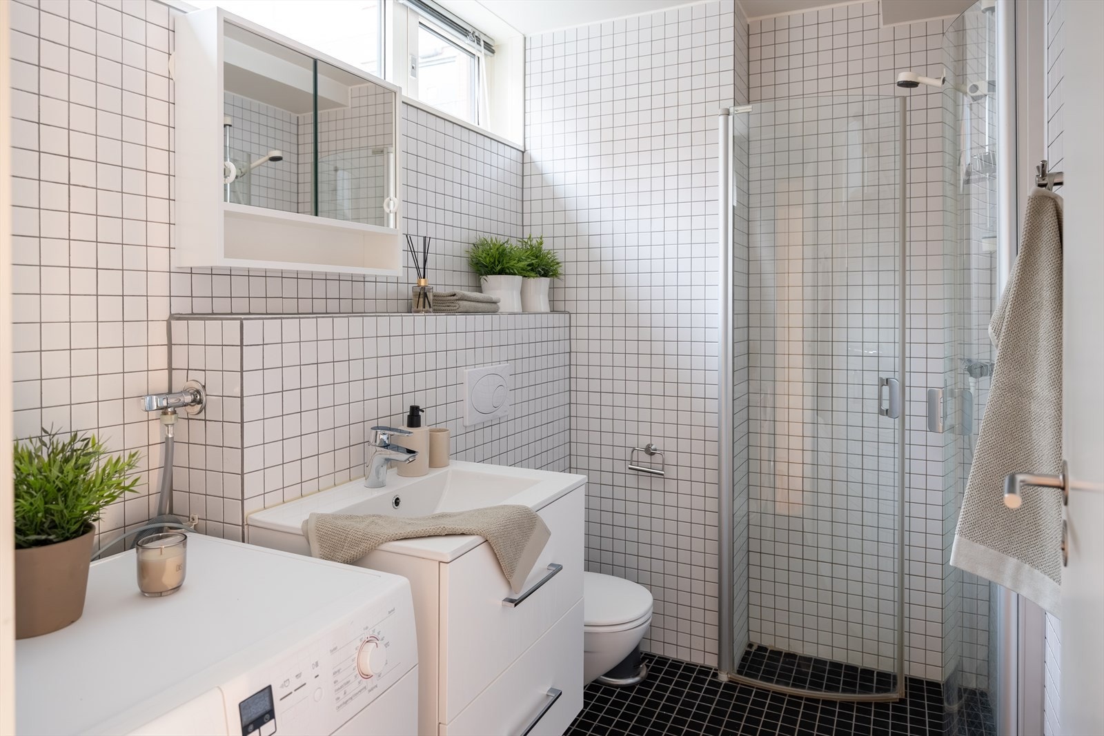 Her får du et flislagt bad med varme i gulv og opplegg til vaskemaskin. Galleribilde