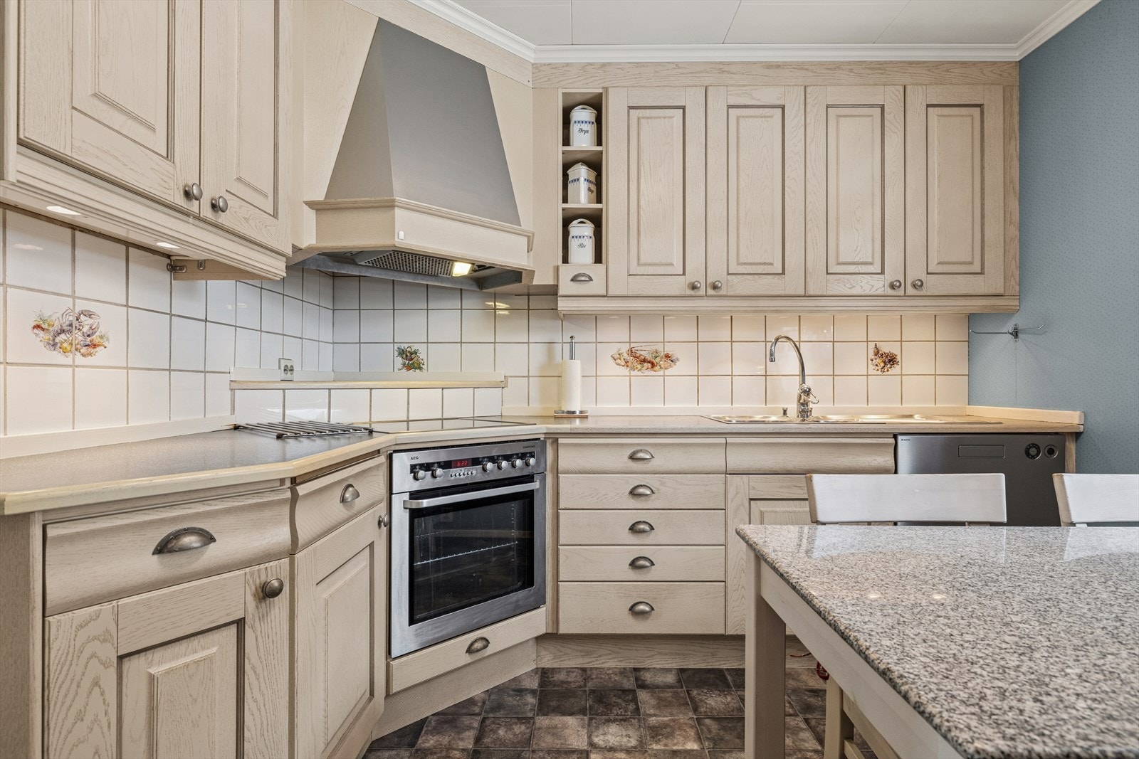 Kjøkken, innredning fra 2004, med profilerte fronter og laminert benkeplate. Stålkum med ett grep blandebatteri. Flis på vegg under overskap. Galleribilde