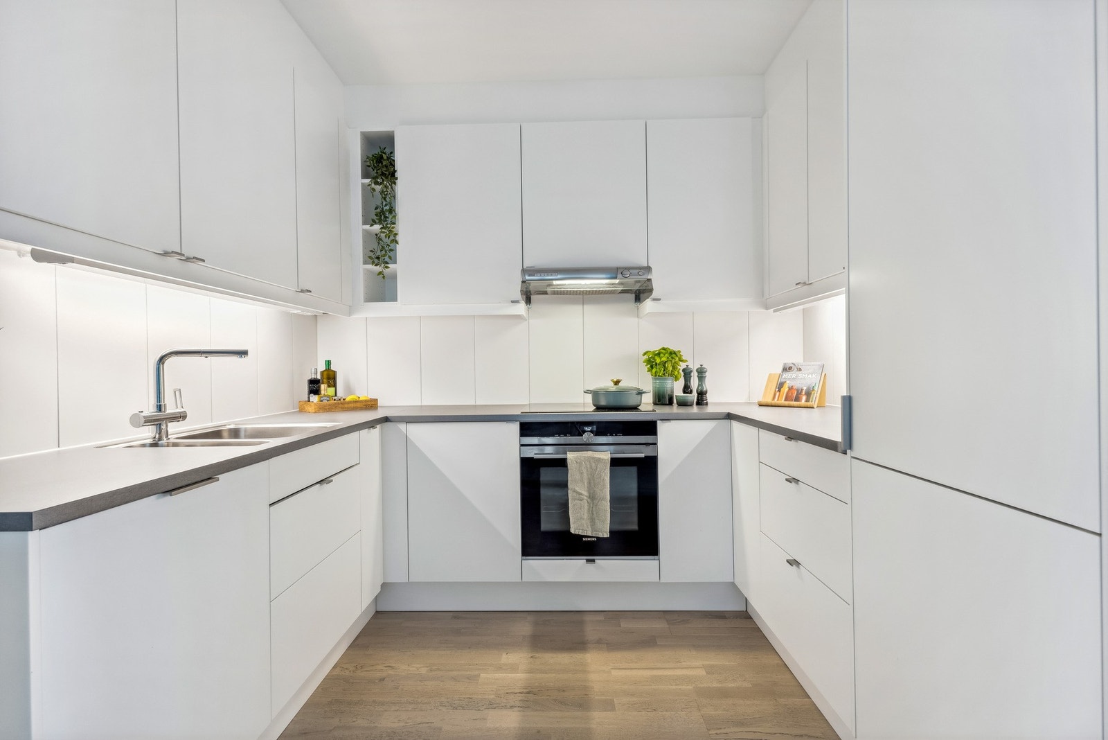 Kjøkkenet er utstyrt med integrert oppvaskmaskin, komfyr, induksjonsplate, kjøleskap og frys. Galleribilde