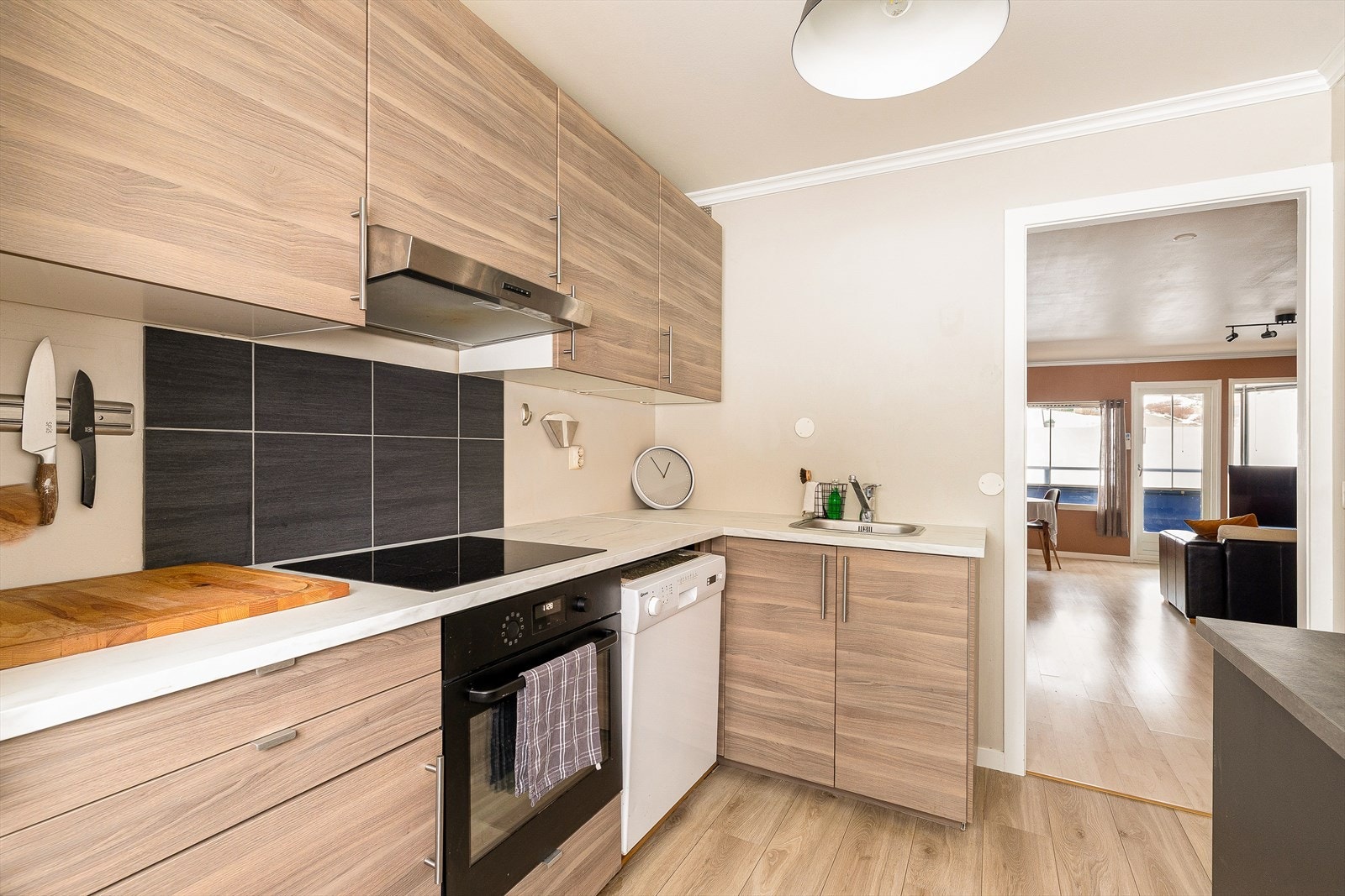 Moderne og stilrent kjøkken med rene linjer og godt med skap- og benkeplass. Praktiske, integrerte løsninger som stekeovn og induksjonstopp gir både et ryddig uttrykk og en funksjonell arbeidsflate - perfekt for matlaging i hverdagen. Galleribilde