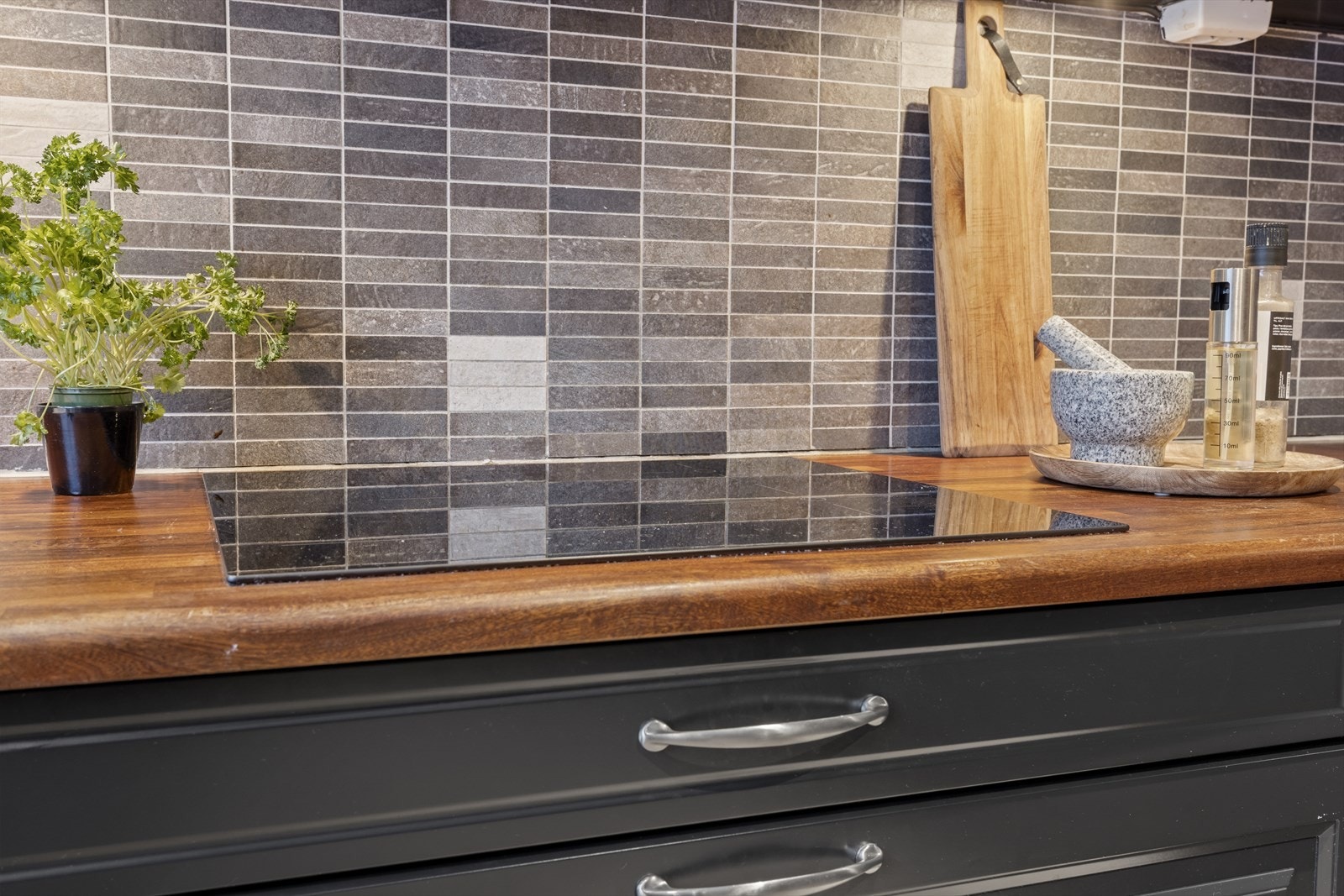 Benkeplaten er i heltre. Kjøkkenet er utstyrt med integrerte hvitevarer bestående av induksjonsplatetopp, stekeovn og oppvaskmaskin. Det er frittstående kjøleskap. Nevnte hvitevarer medfølger ved salg. Galleribilde