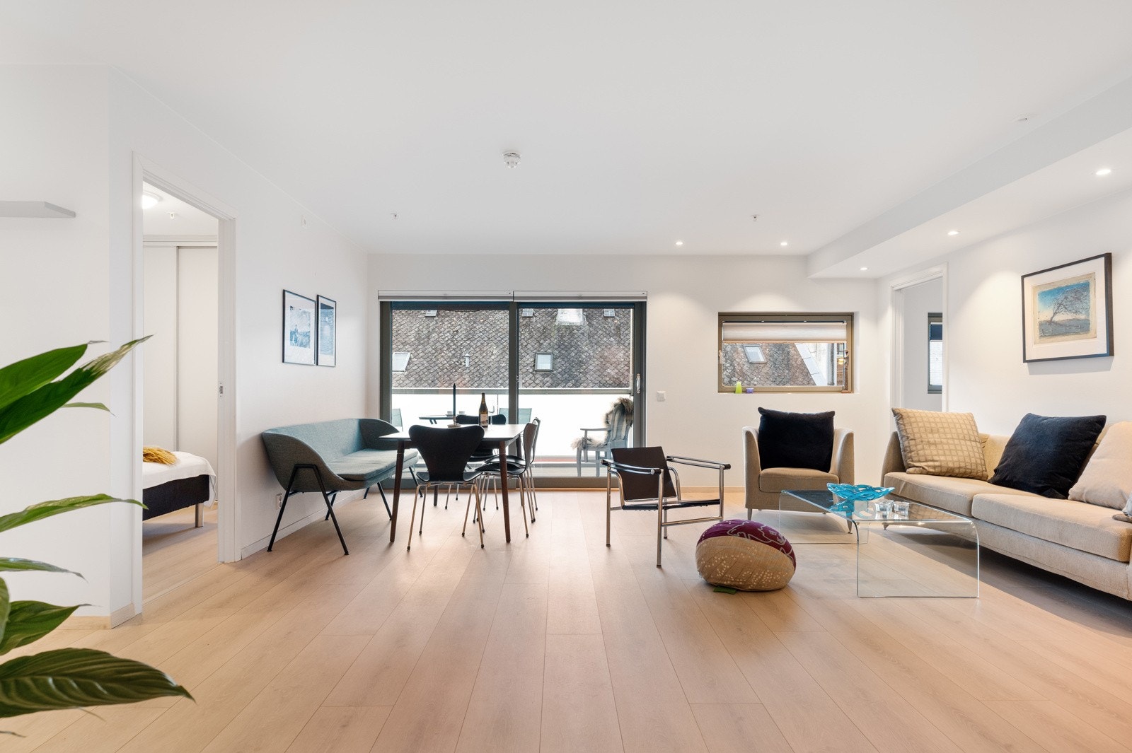 Stue med flott laminat på gulv og lysmalte plater på vegger. Galleribilde