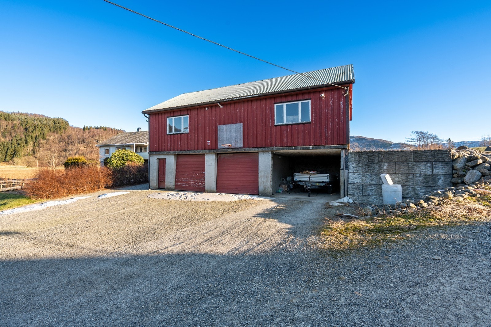 Romslig garasje med plass til flere biler og stort potensial for den som ønsker å sette sitt eget preg. Galleribilde